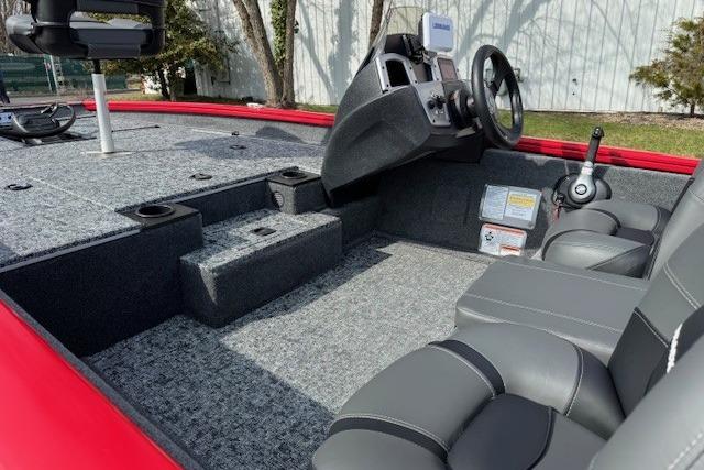 2026 Tracker Pro Team 175 boat interior with gray seating and steering console.