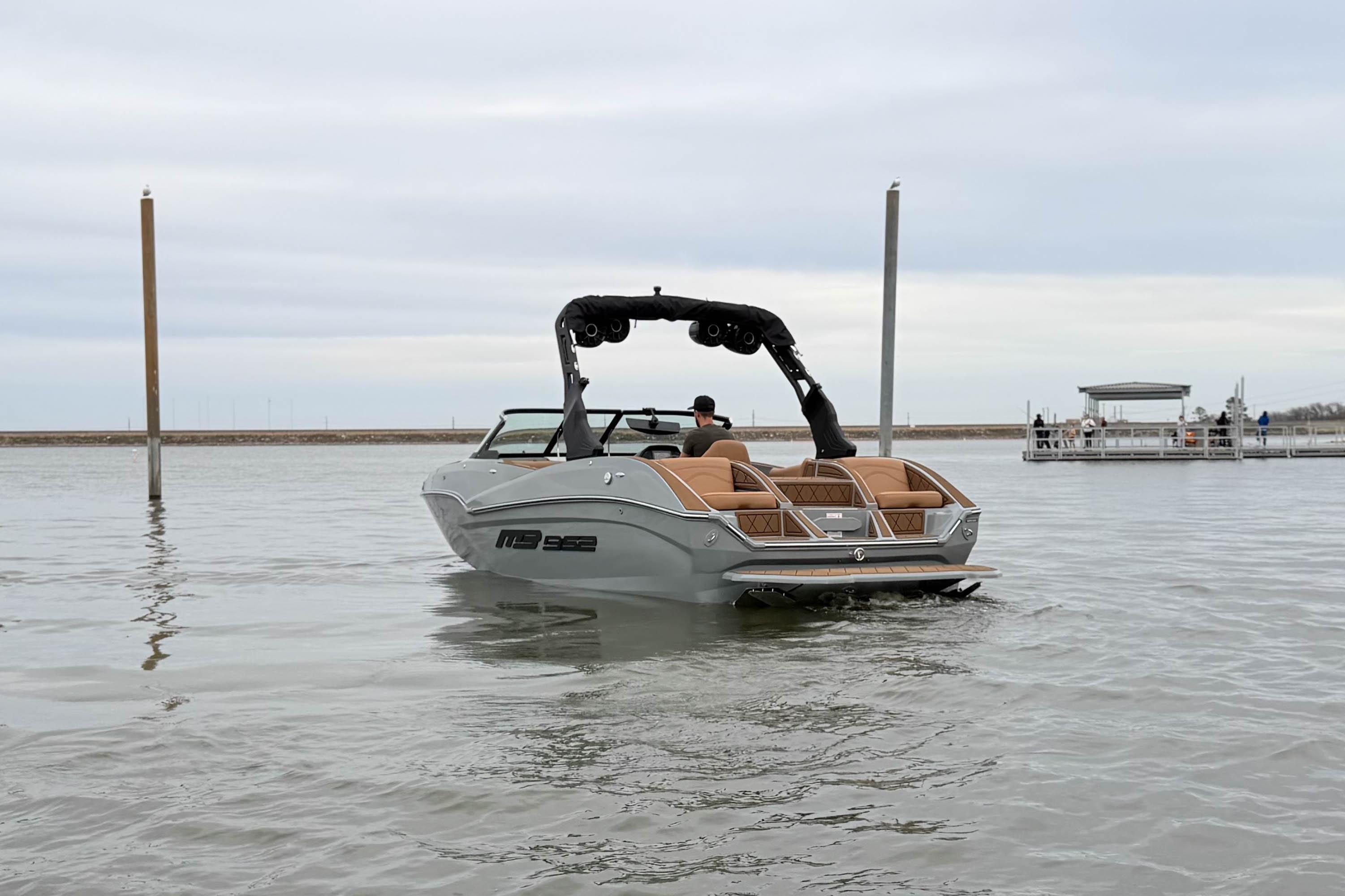 2026 MB B52 21 Alpha boat on calm water, rear view.