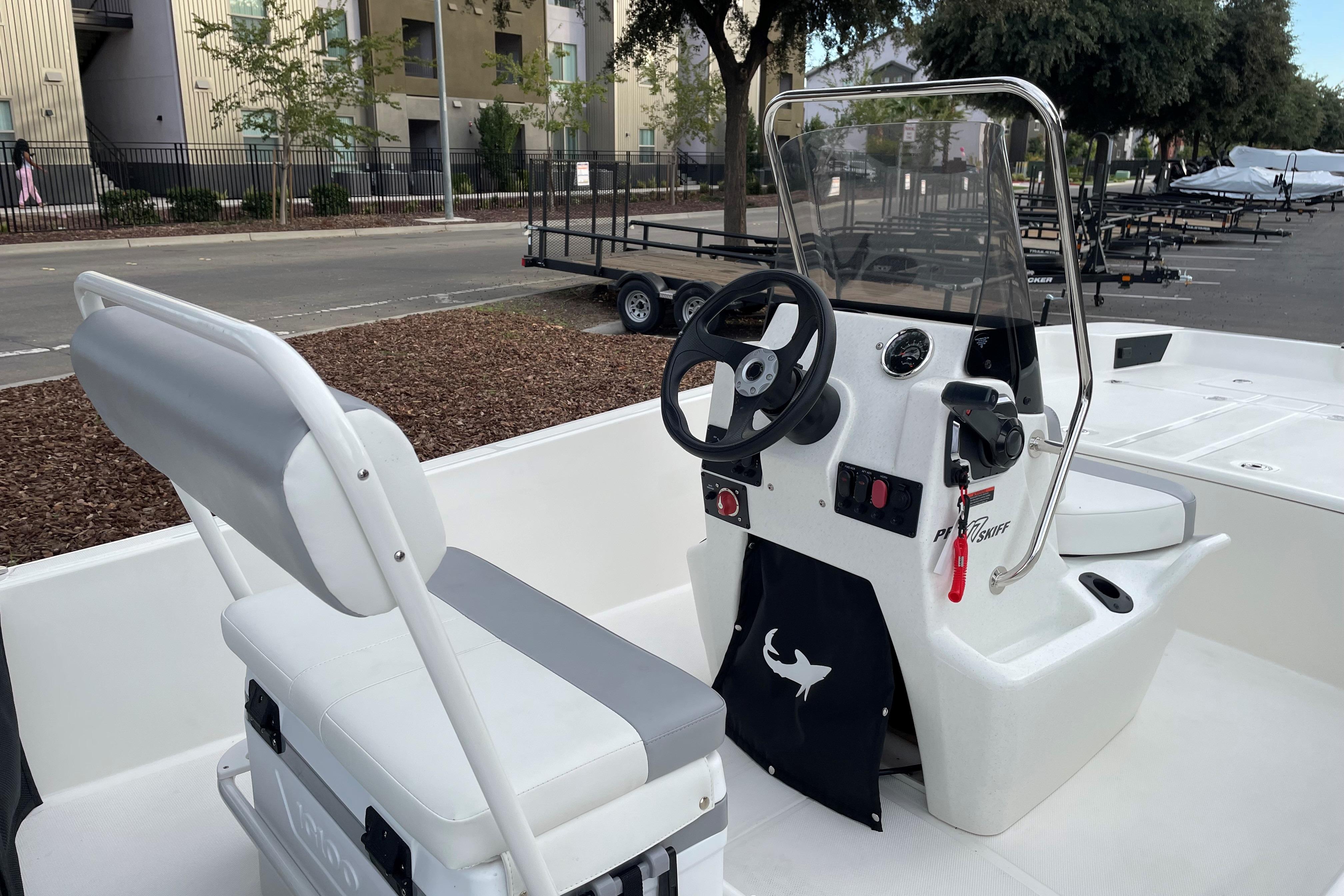 2025 Mako Pro Skiff 17 CC boat interior with steering console and seating.