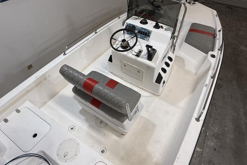 1996 Century 1800 Center Console boat interior with steering wheel and seating.