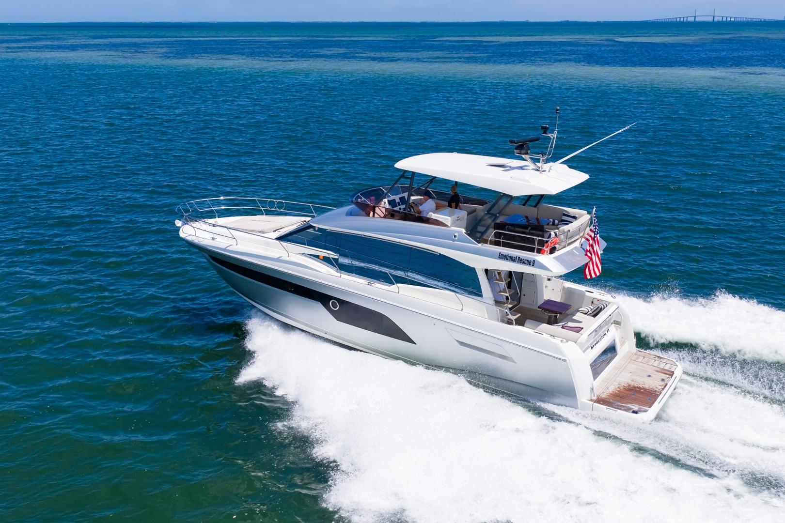 2022 Prestige 520 yacht cruising on open blue ocean waters.