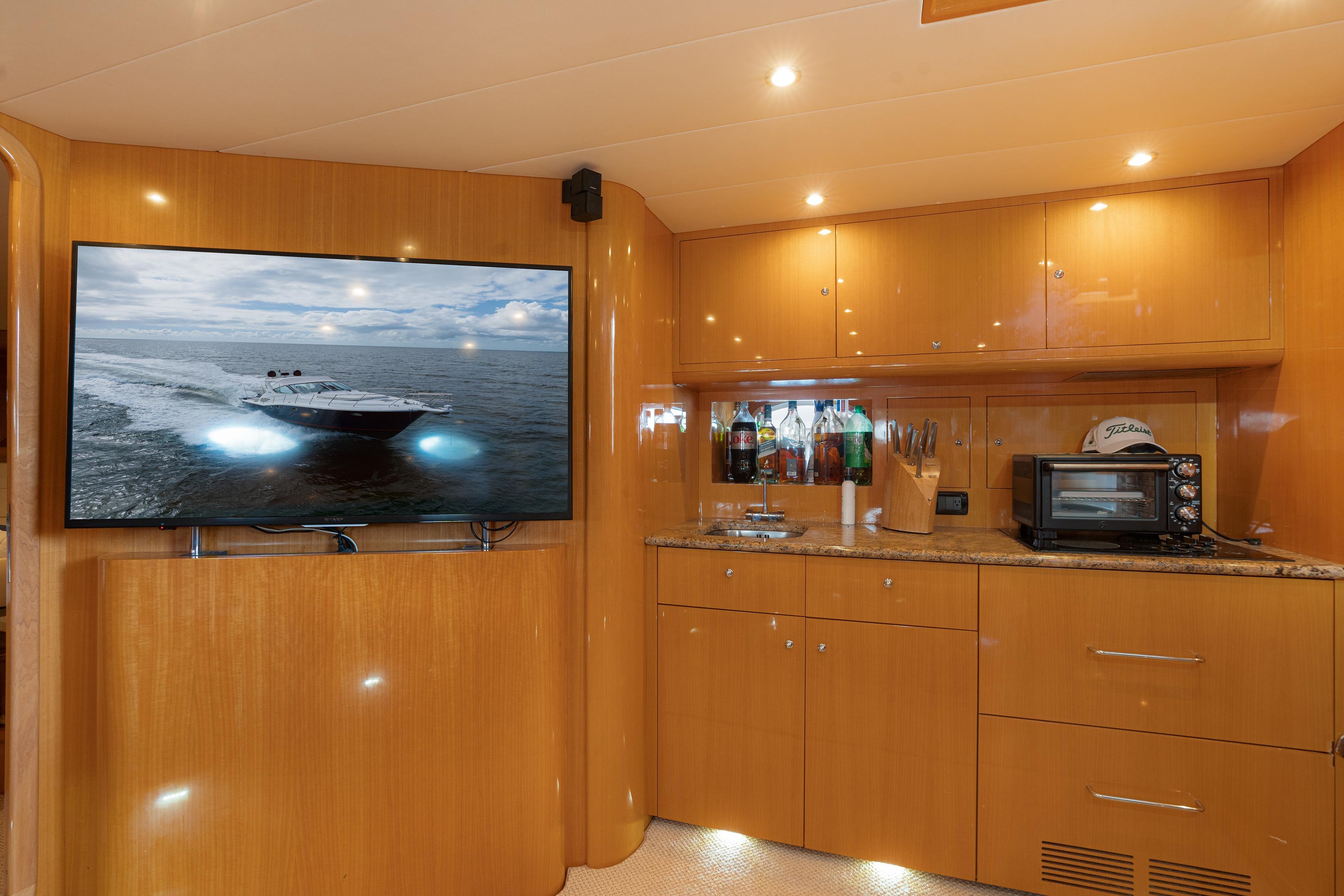 Interior of 2001 Uniesse 48 Open yacht with modern kitchen and large TV.