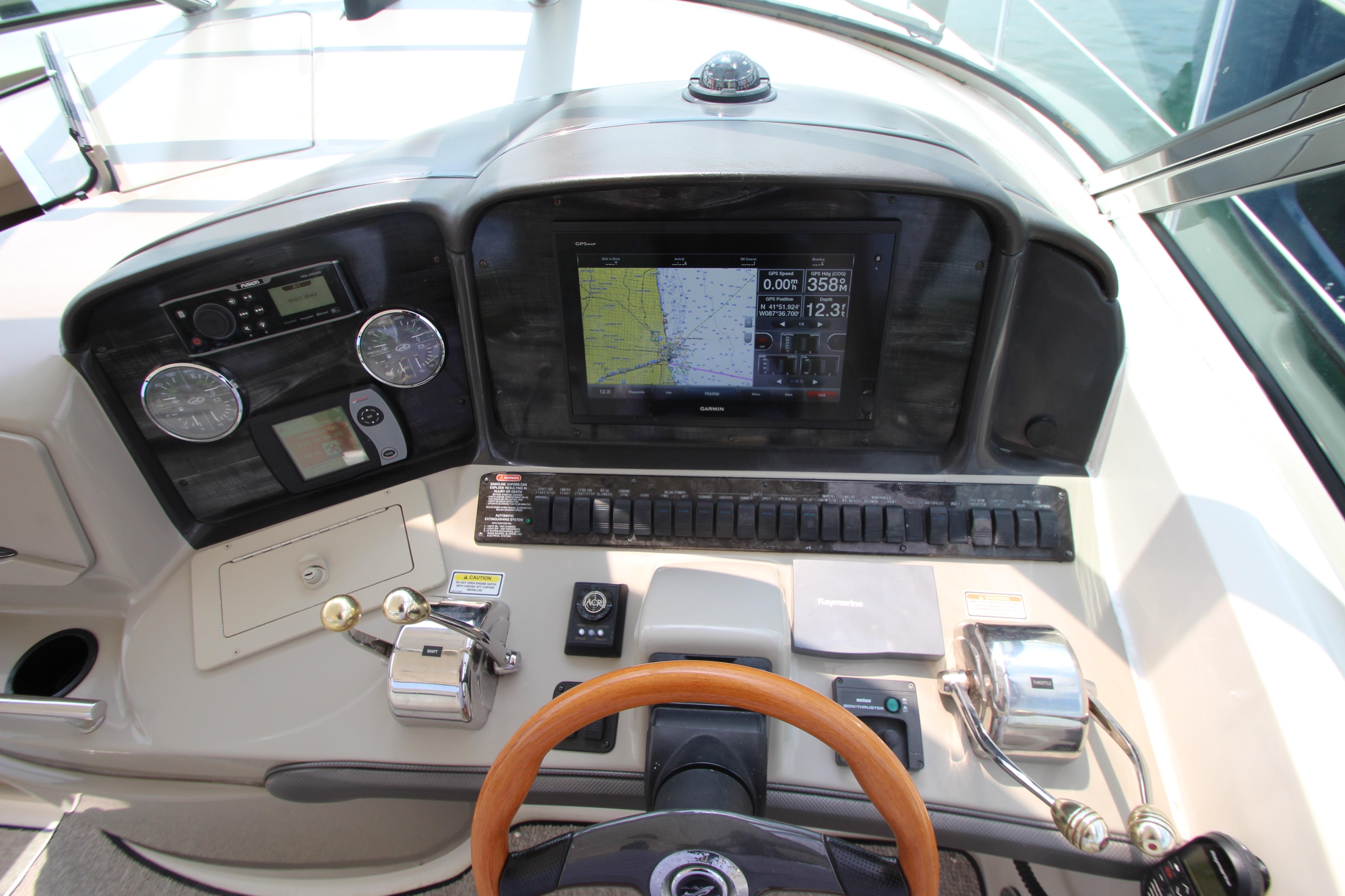 2004 Sea Ray 40 Sundancer helm with navigation controls and steering wheel.