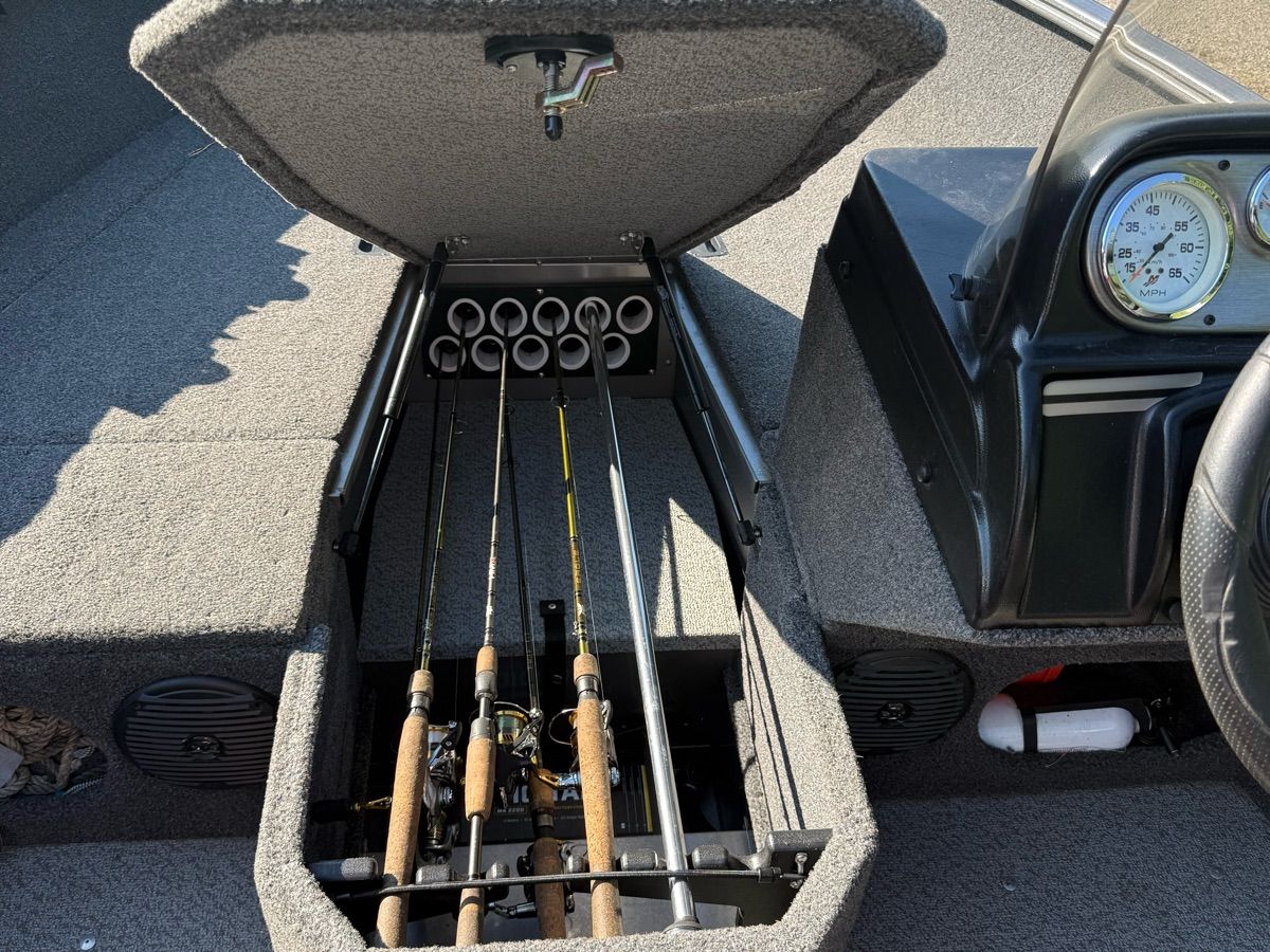 The image shows the interior of a 2019 Lund 1775 Adventure SS boat with fishing rod storage.