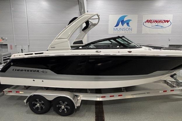 2026 Chaparral SSX 8 boat on trailer in showroom, Munson Marine signs visible.