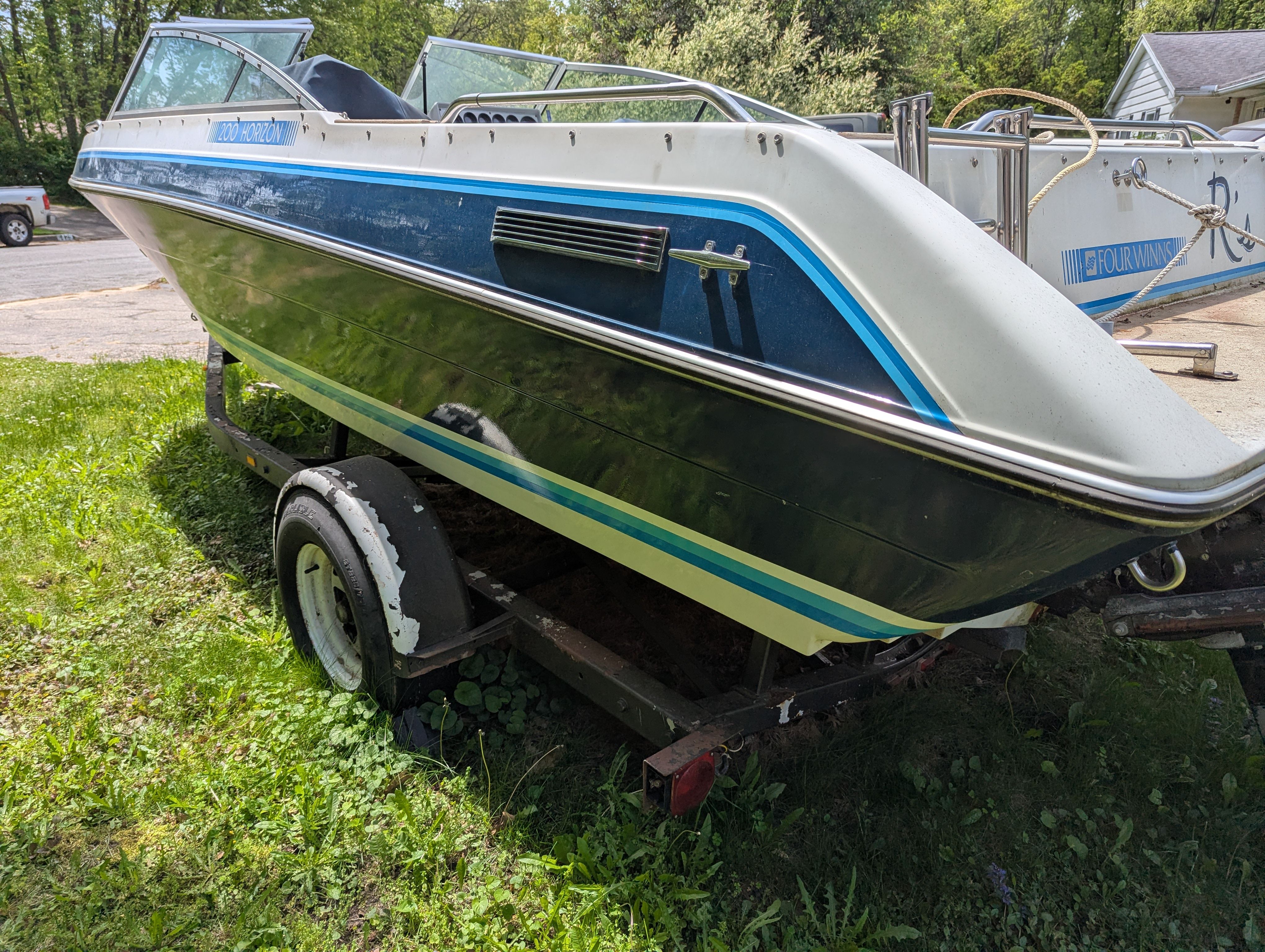 1988 Four Winns 200 Horizon boat on trailer outdoors.