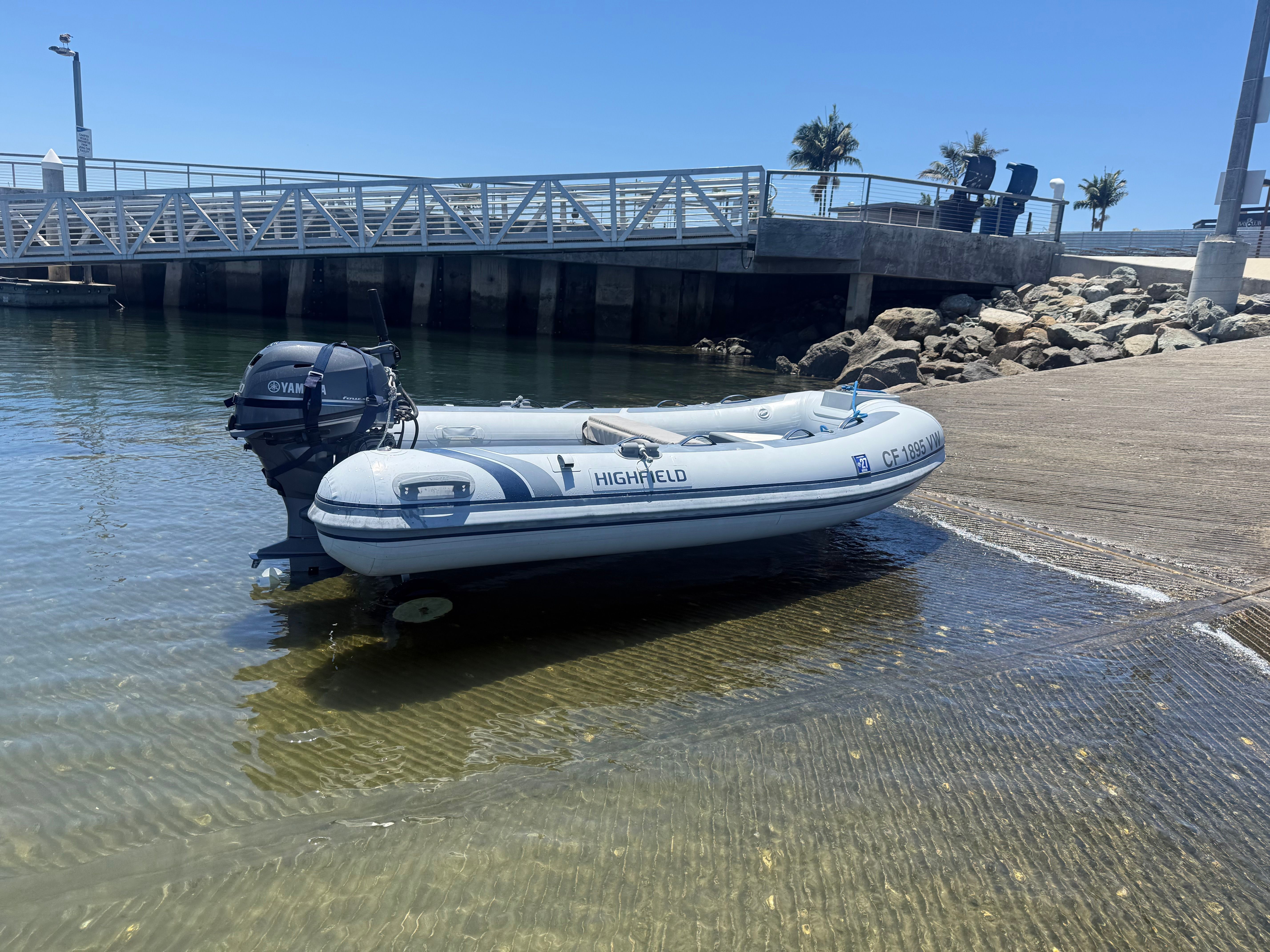 A Highfield Classic 310 inflatable boat is on a ramp in the water.