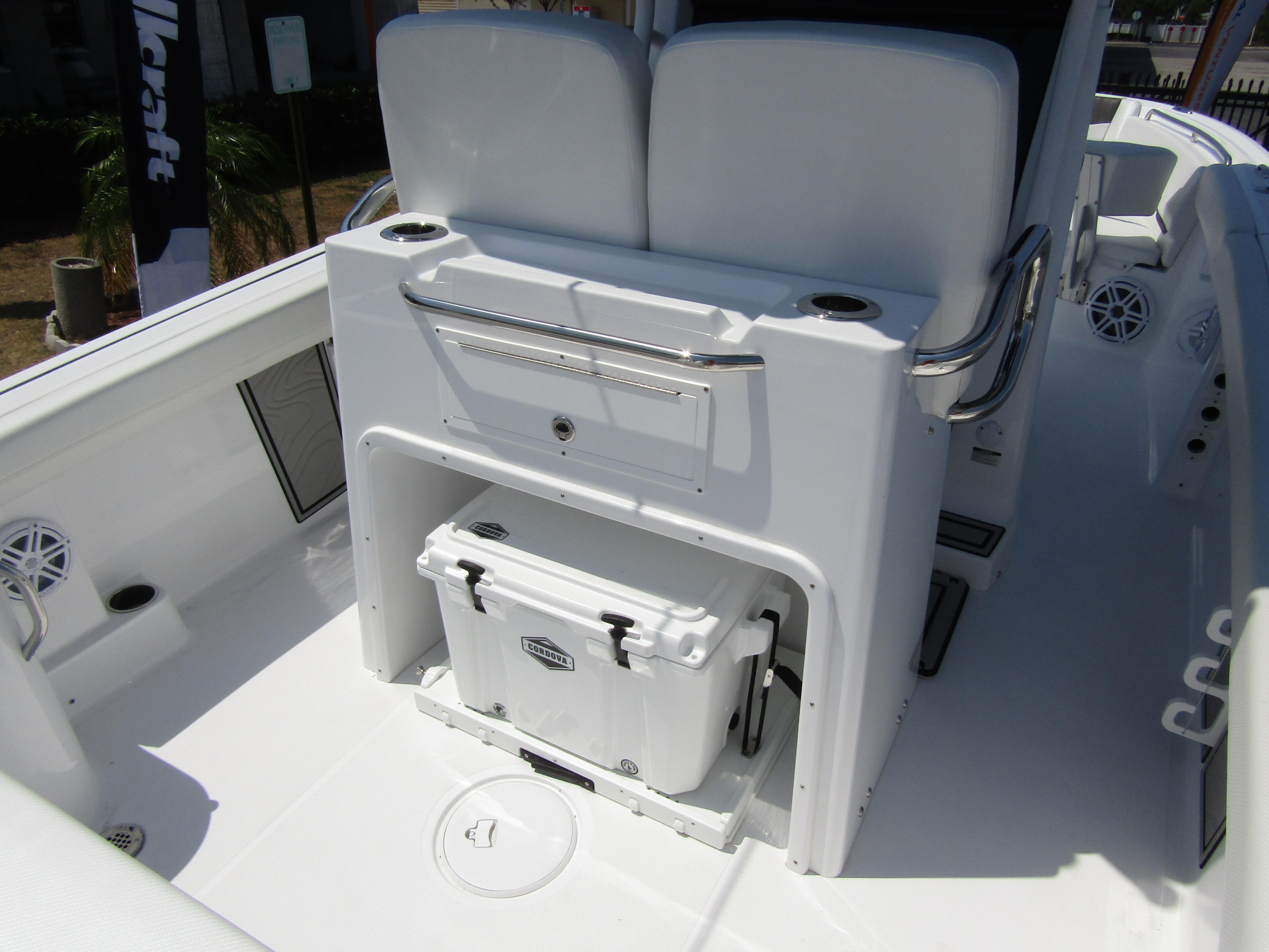 2024 Wellcraft 243 Fisherman boat interior with cooler storage and seating.