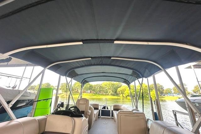 2019 Sun Tracker Party Barge 22 XP3 pontoon boat interior with canopy on a lake.
