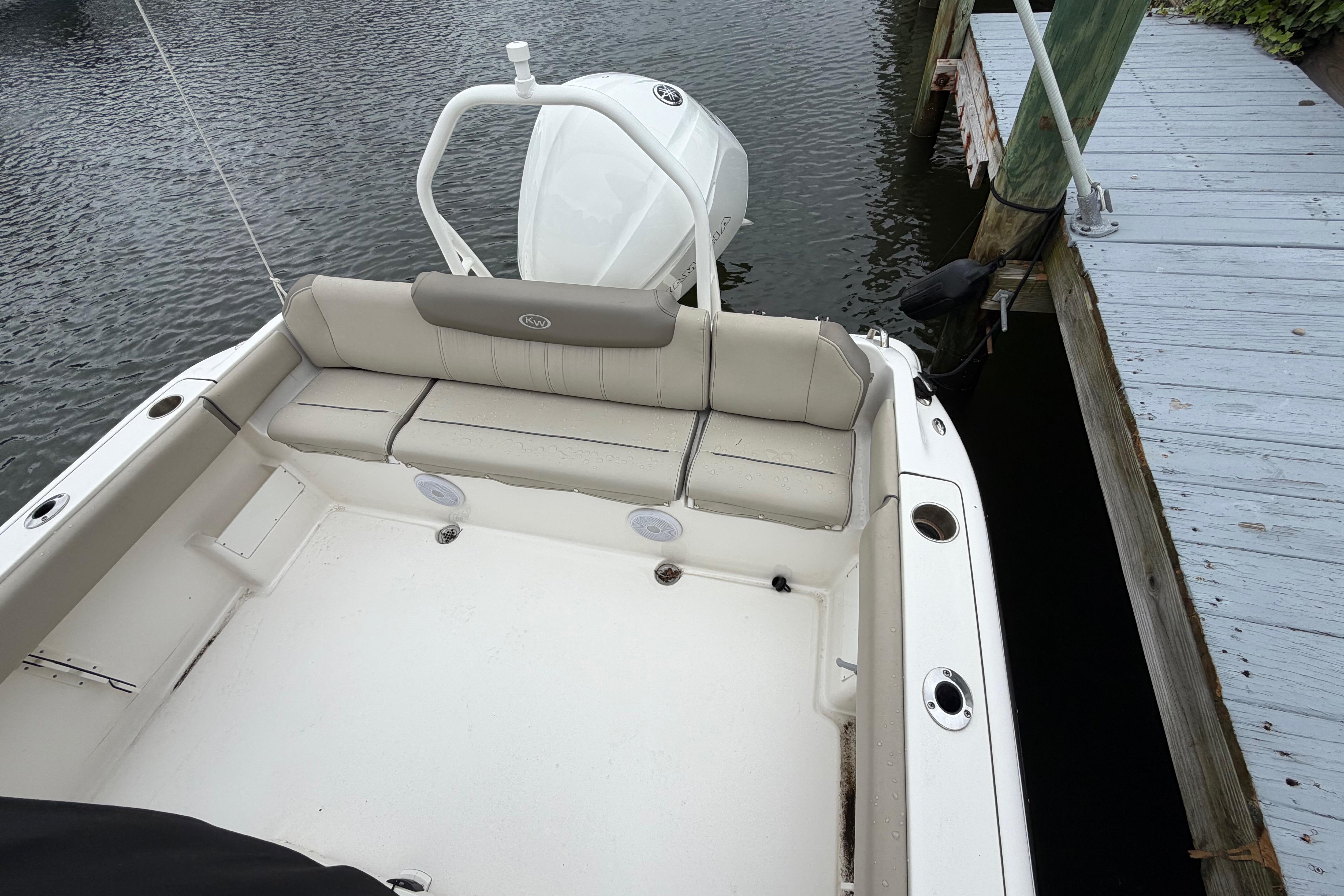 2022 Key West 239 FS boat docked, featuring spacious seating and sleek design.
