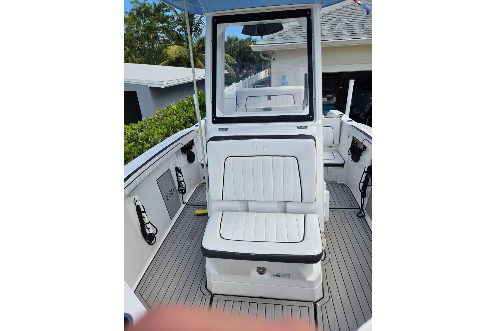 2024 Yamaha Boats 222 FSH Sport E interior with white seating and sleek design.