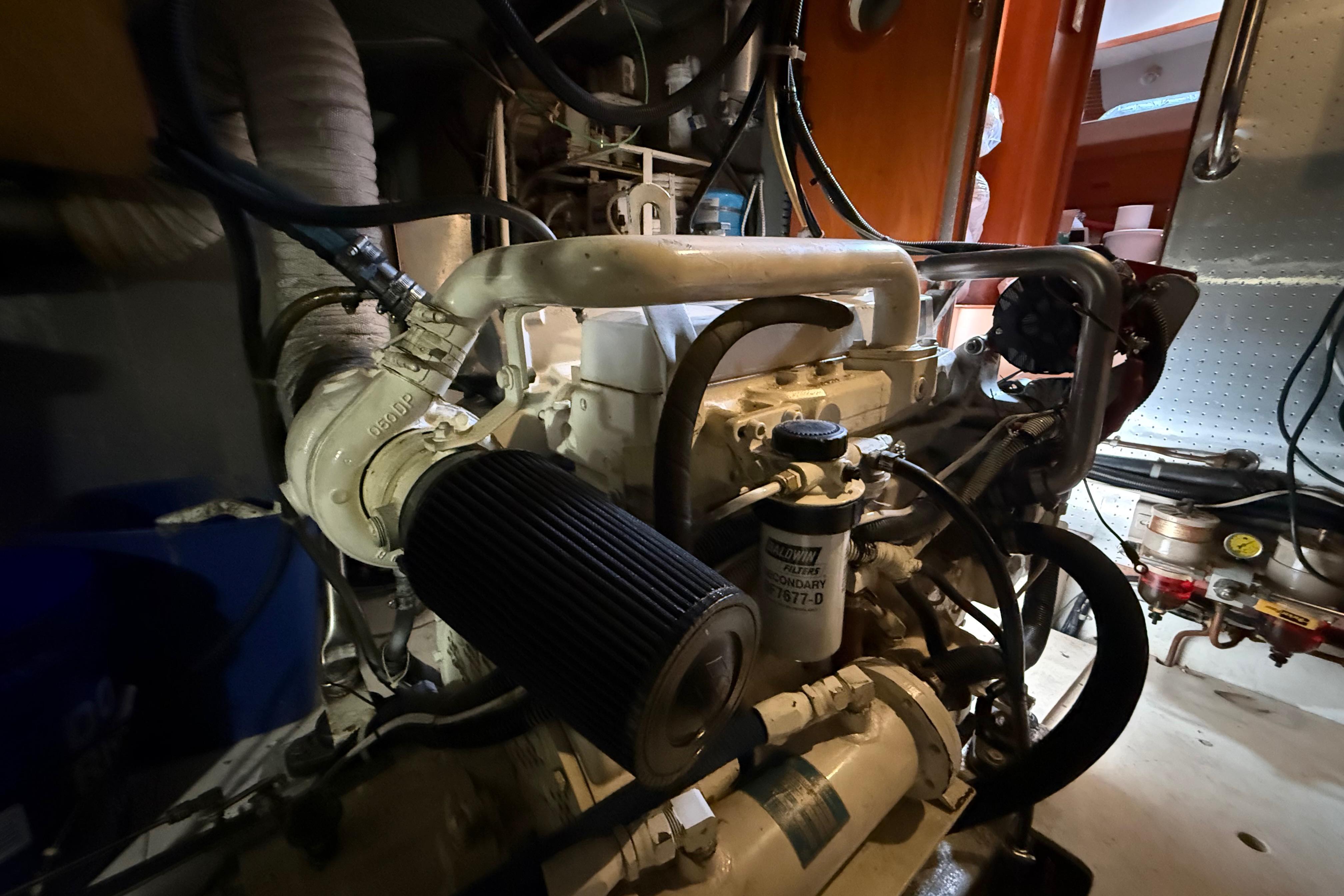 Engine room of a 2001 Kadey-Krogen 39 boat, showcasing mechanical components and filters.