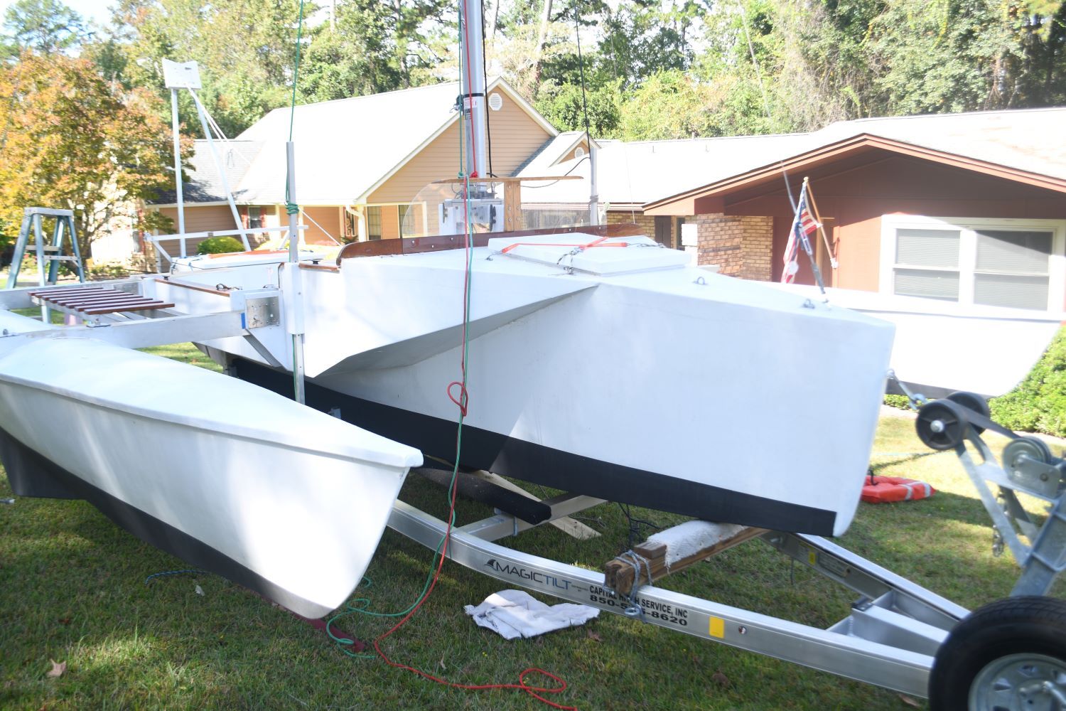 Custom Strike 18 trimaran on trailer in yard, year 2020.