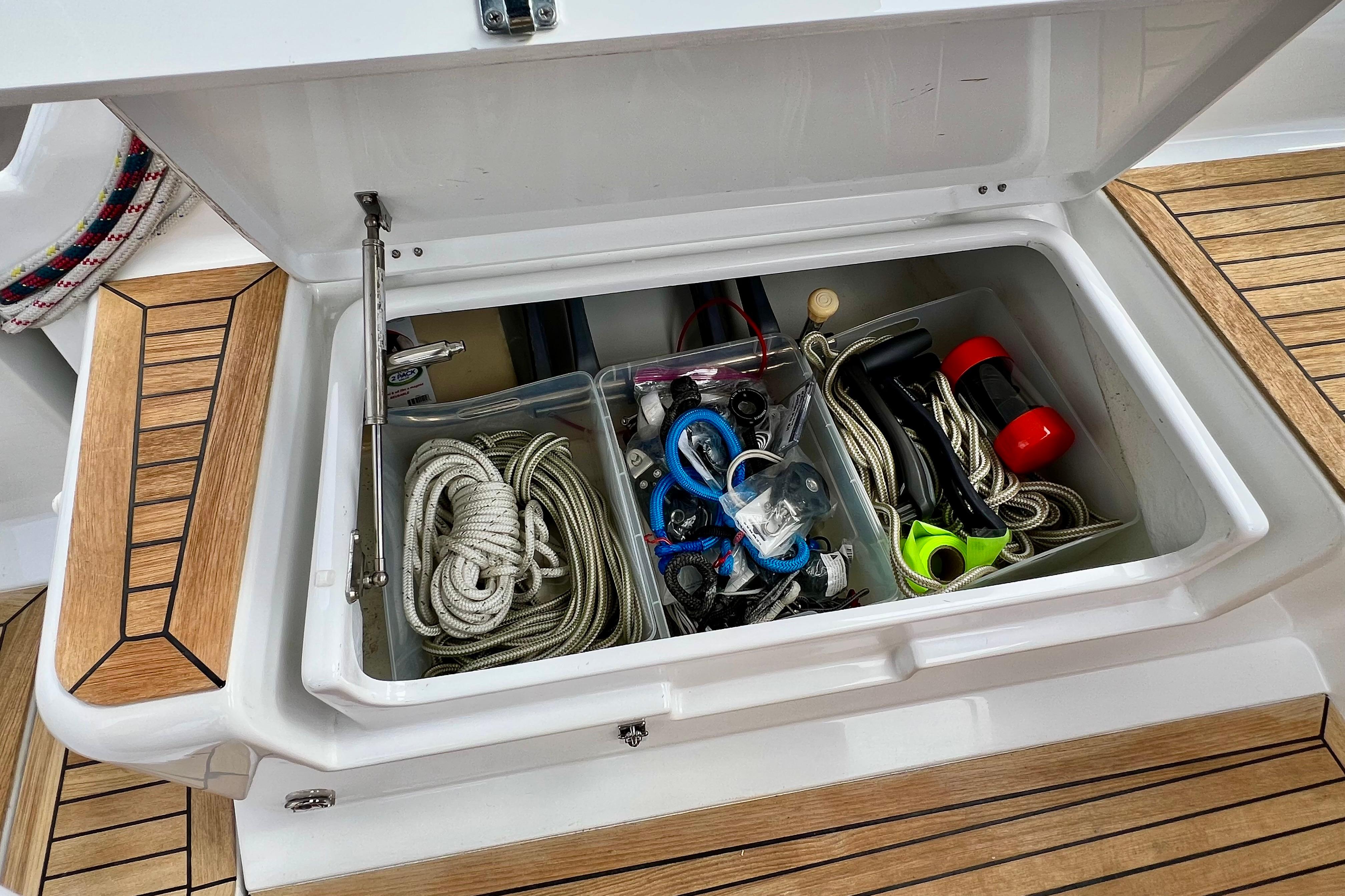 Storage compartment on a 2016 Hanse 455 yacht, containing ropes and sailing gear.