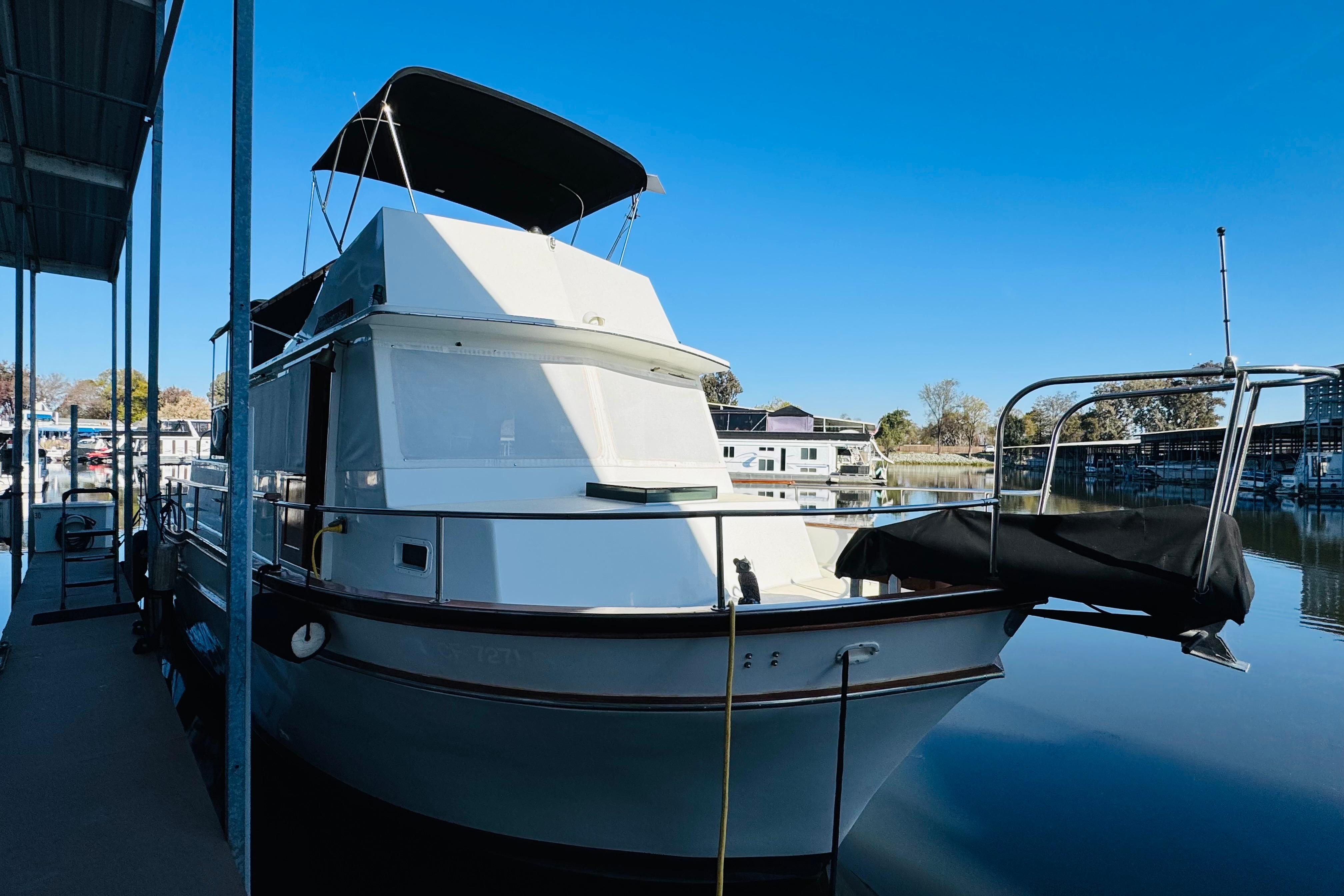 1978 Californian 42 LRC yacht docked at marina under clear blue sky.