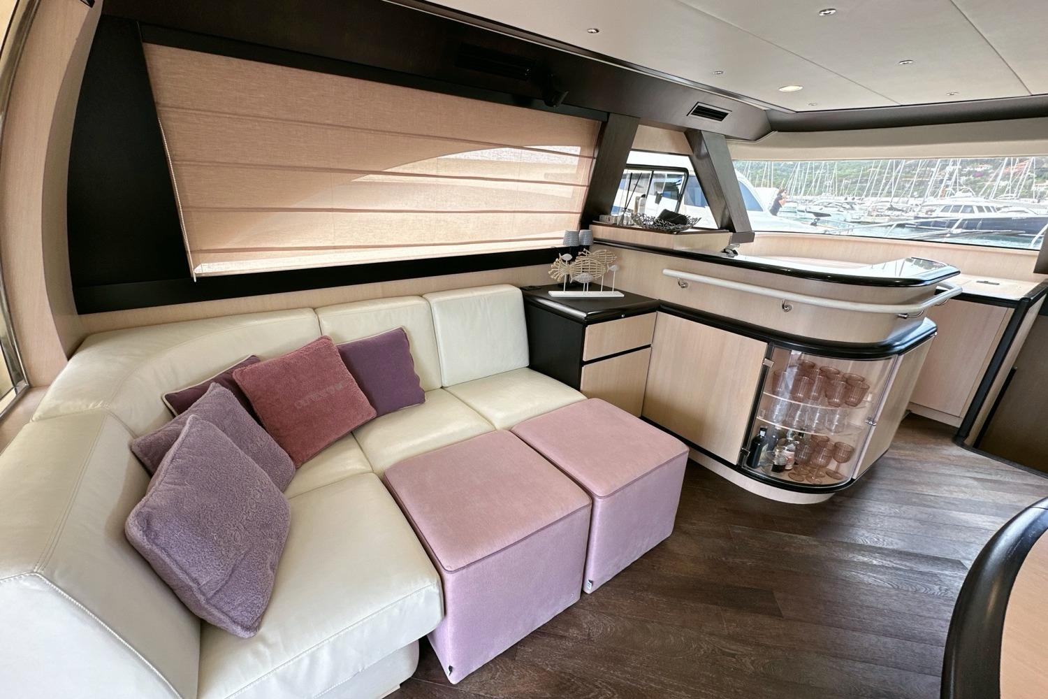 Luxurious interior of 2010 Abati Yachts 64 Freeport with plush seating and elegant bar area.