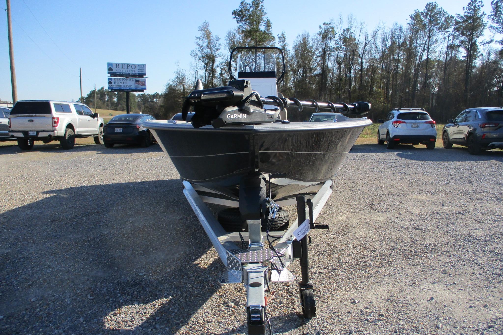 2026 Vexus ACX2210 boat on trailer in parking lot, surrounded by cars and trees.