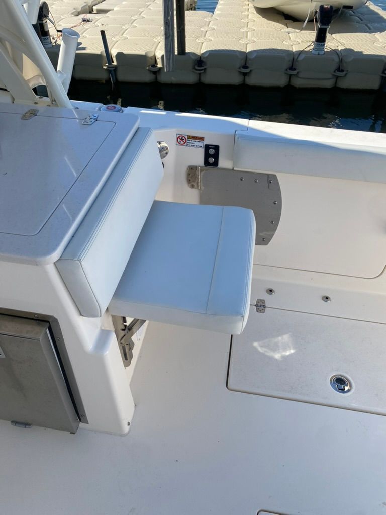 Interior of a 2023 Cobia 330 boat with seating area.