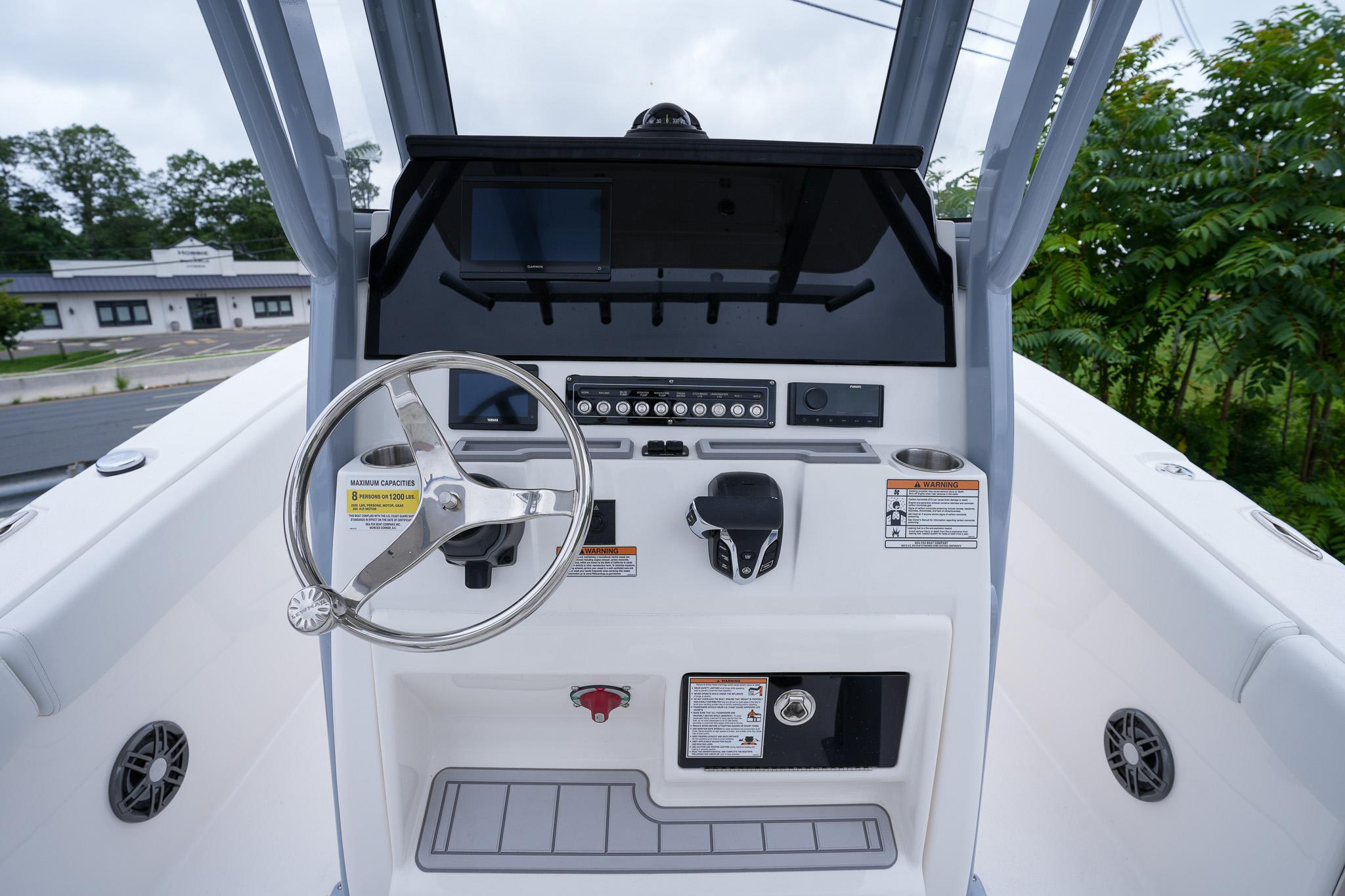 2026 Sea Fox 228 Commander boat dashboard with steering wheel and control panel.