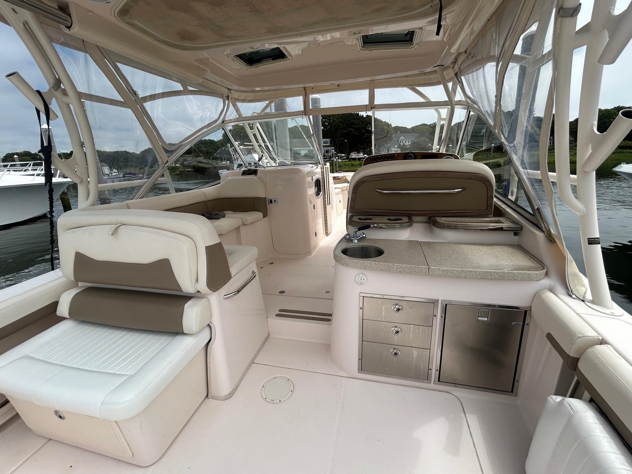 2013 Grady-White Freedom 335 boat interior with seating, kitchenette, and storage.