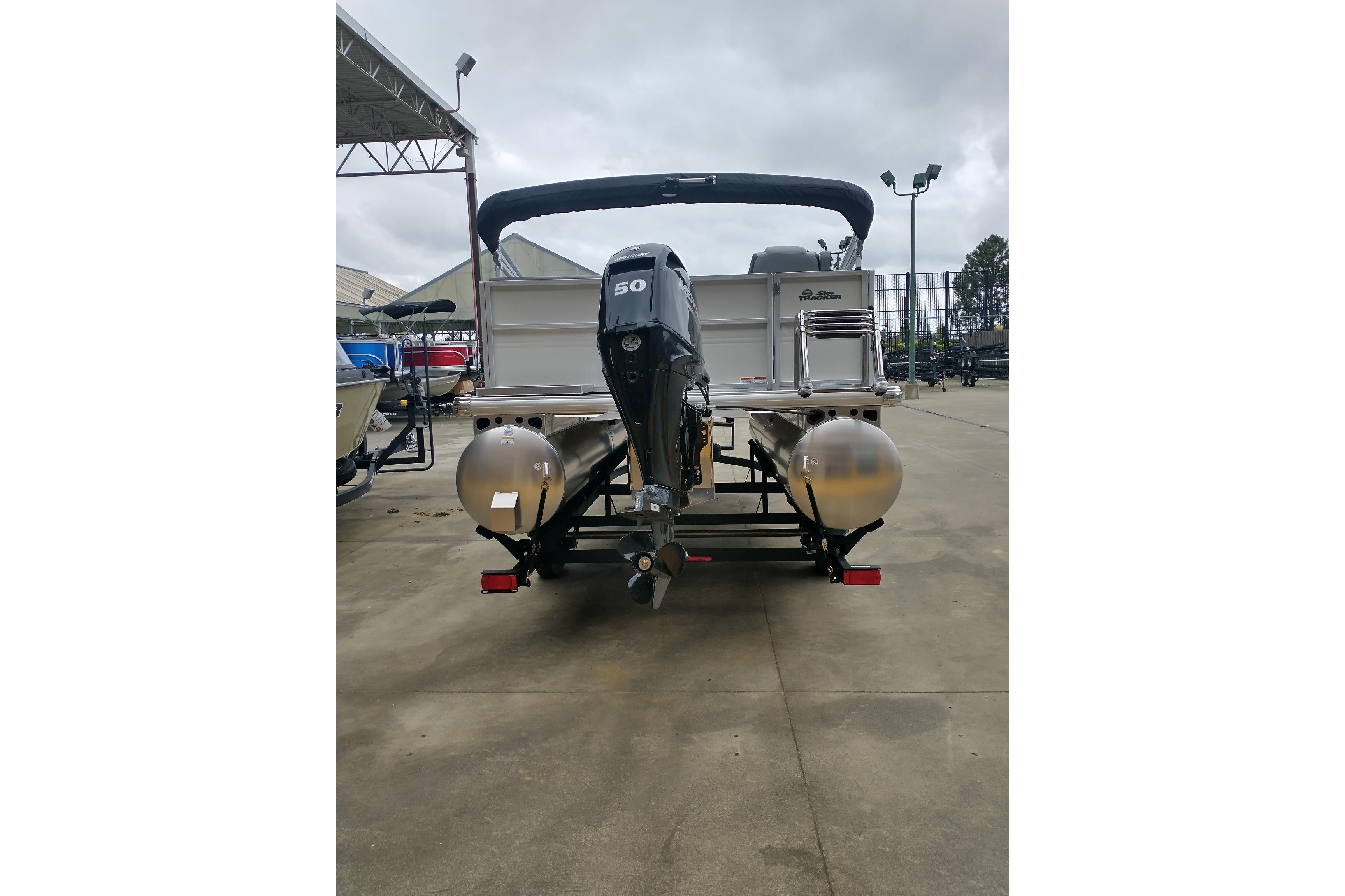 2026 Sun Tracker Party Barge 16 DLX pontoon boat with 50 HP motor, rear view.