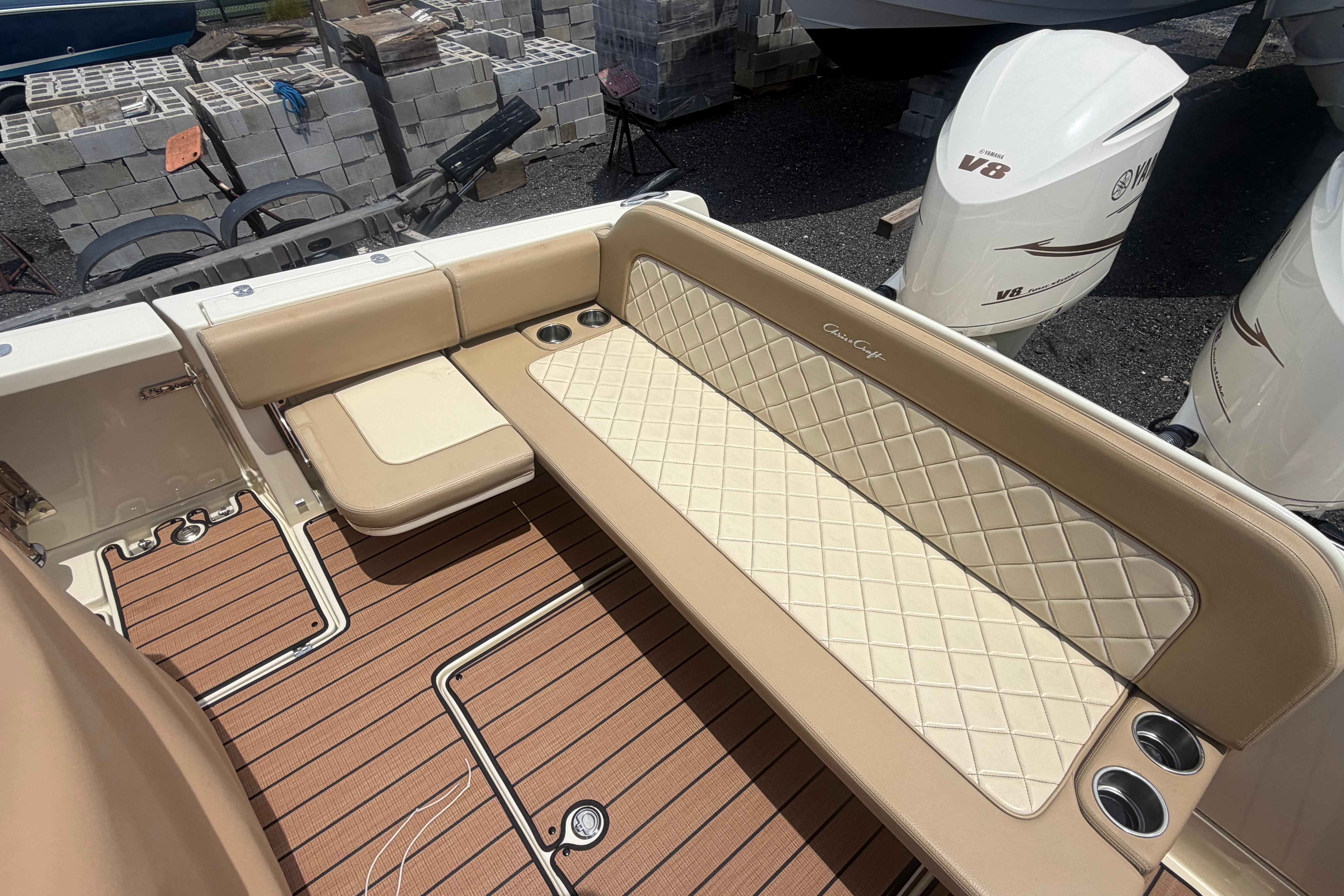 2017 Chris-Craft Catalina 34 boat interior with beige seating and teak flooring.