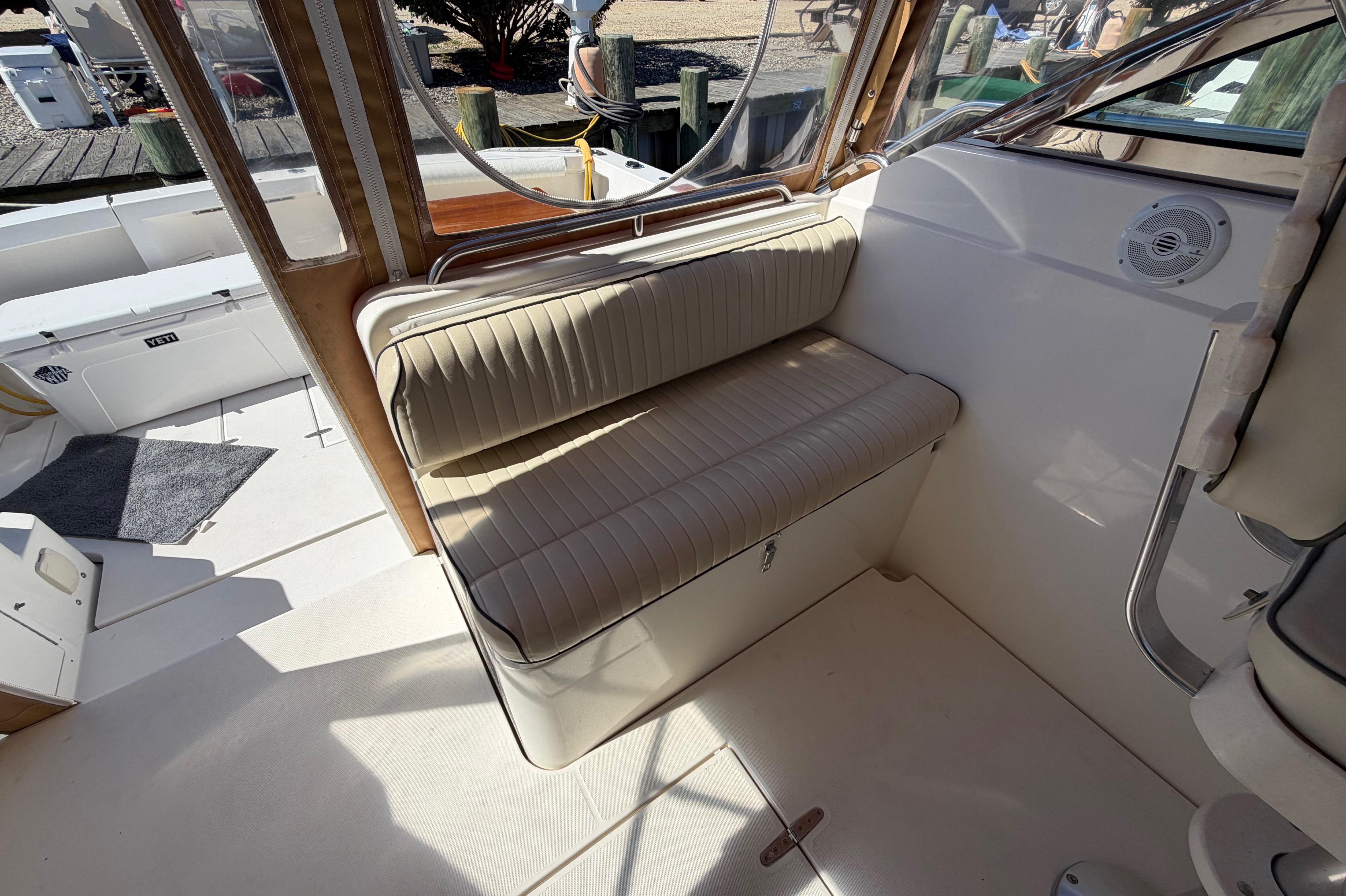 Interior seating of a 2000 Sabreline 36 Express boat, featuring beige cushioned bench.