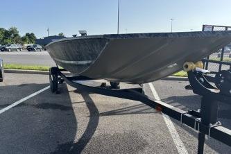 2026 Tracker Grizzly 1648 Utility boat on trailer in parking lot.