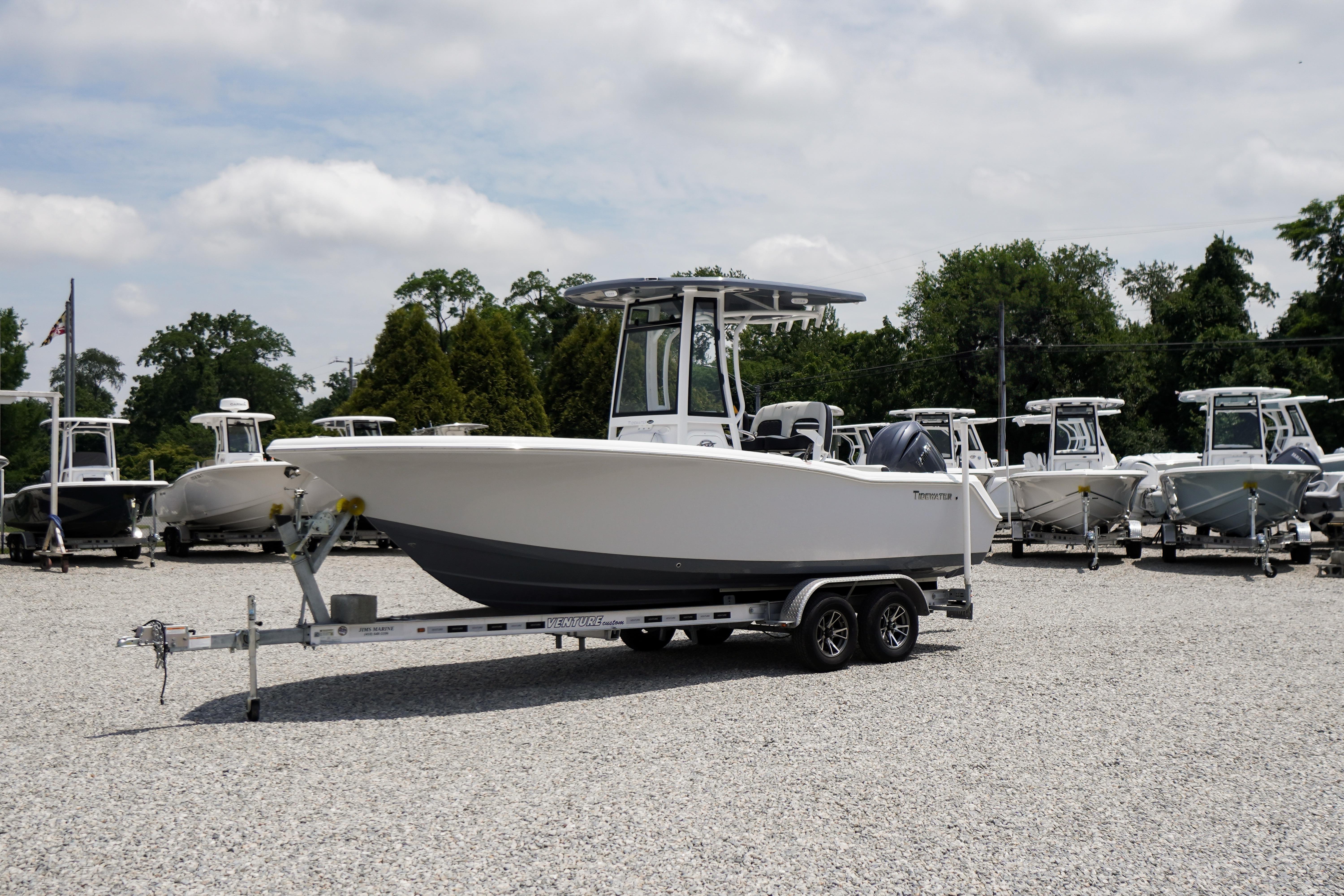 2027 Tidewater 220 CC Adventure boat on trailer in outdoor showroom.