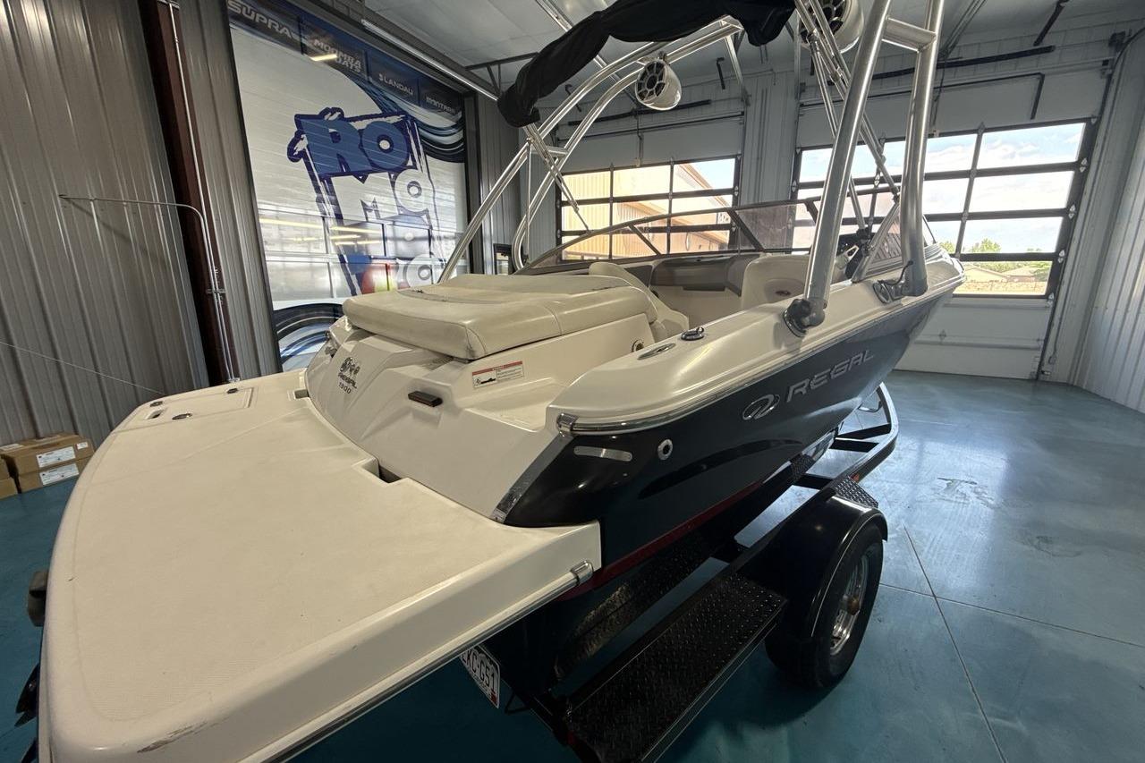 2012 Regal 1900 Bowrider boat in a garage, showcasing sleek design and modern features.