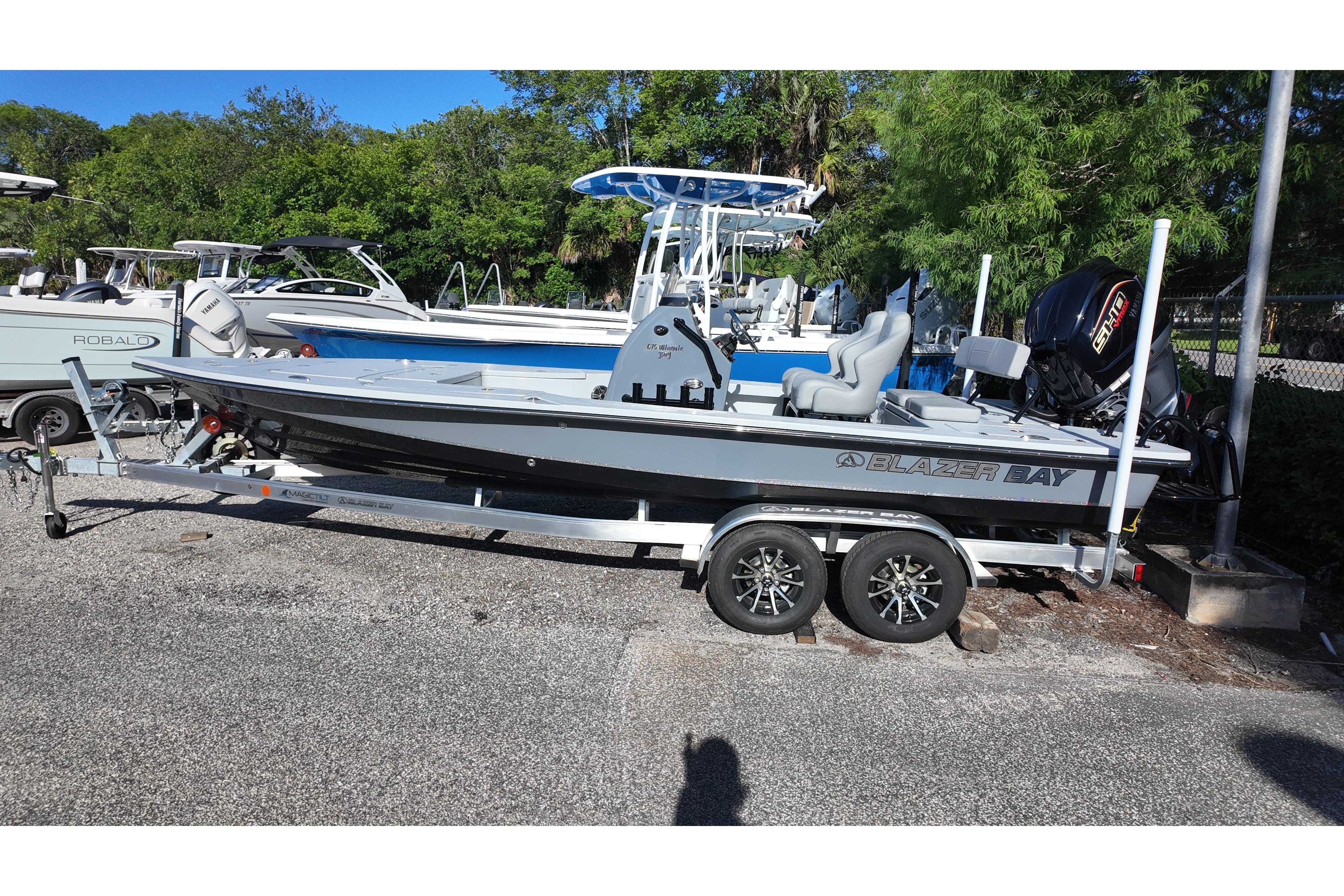 2026 Blazer Bay 675 Ultimate Bay boat on trailer, parked outdoors.
