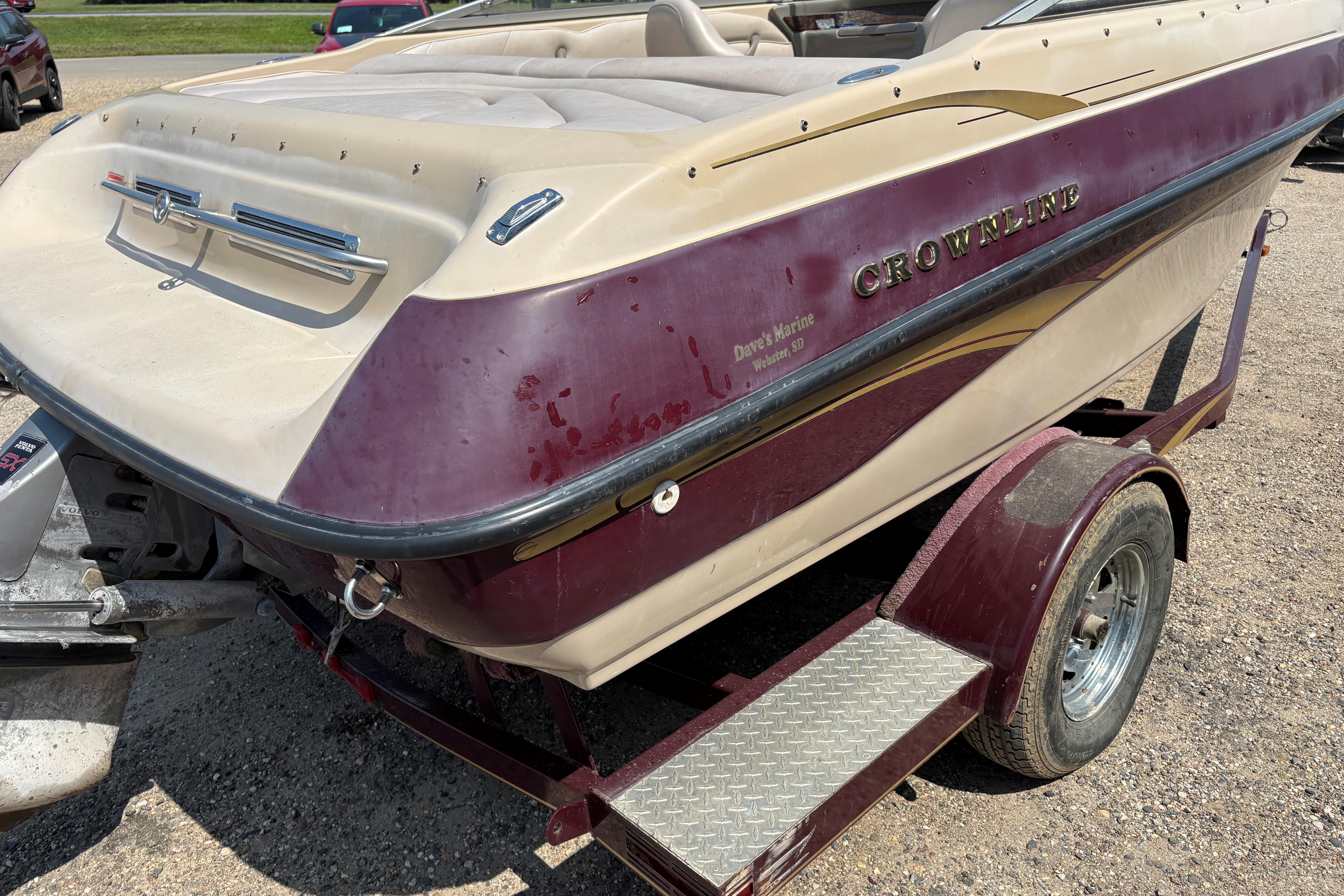 2001 Crownline 18' boat on trailer, maroon and beige color scheme, parked outdoors.
