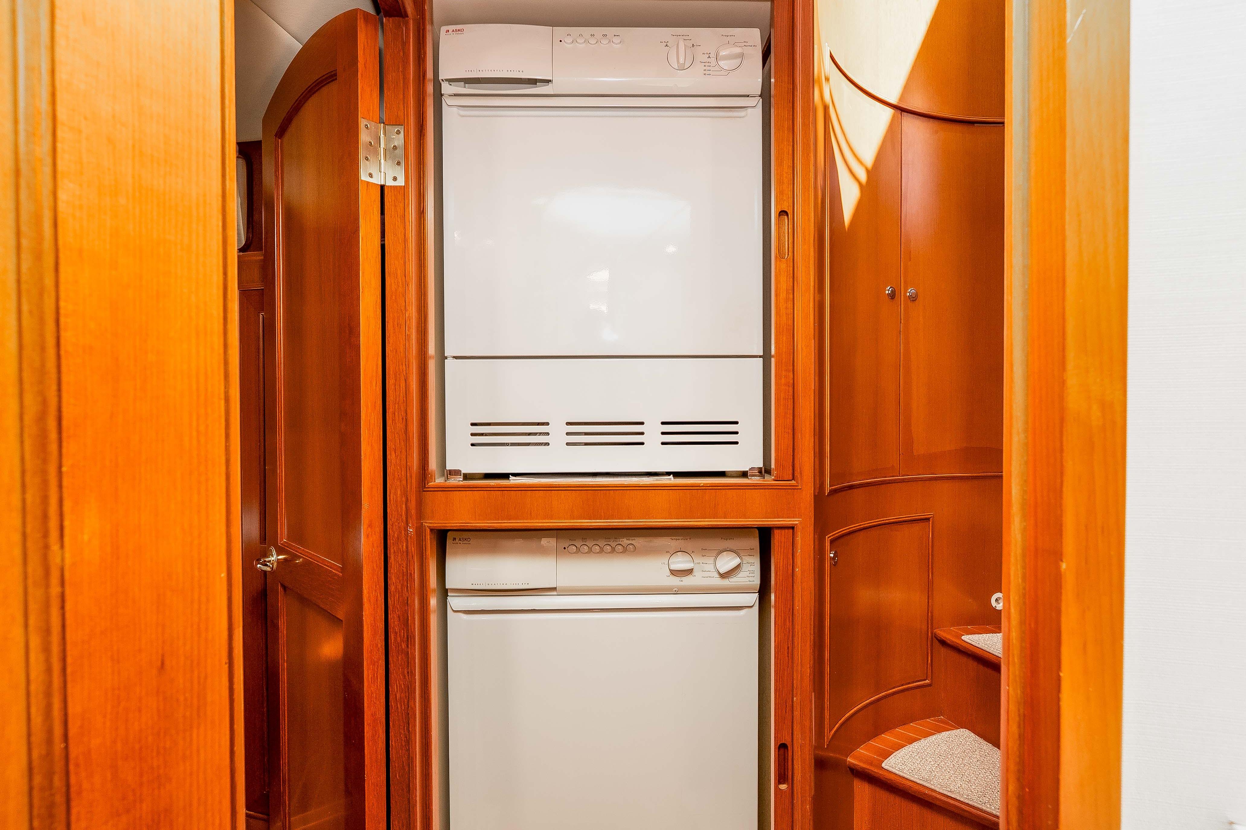 Laundry area in 2005 Offshore Yachts 54 Pilothouse, featuring stacked washer and dryer.