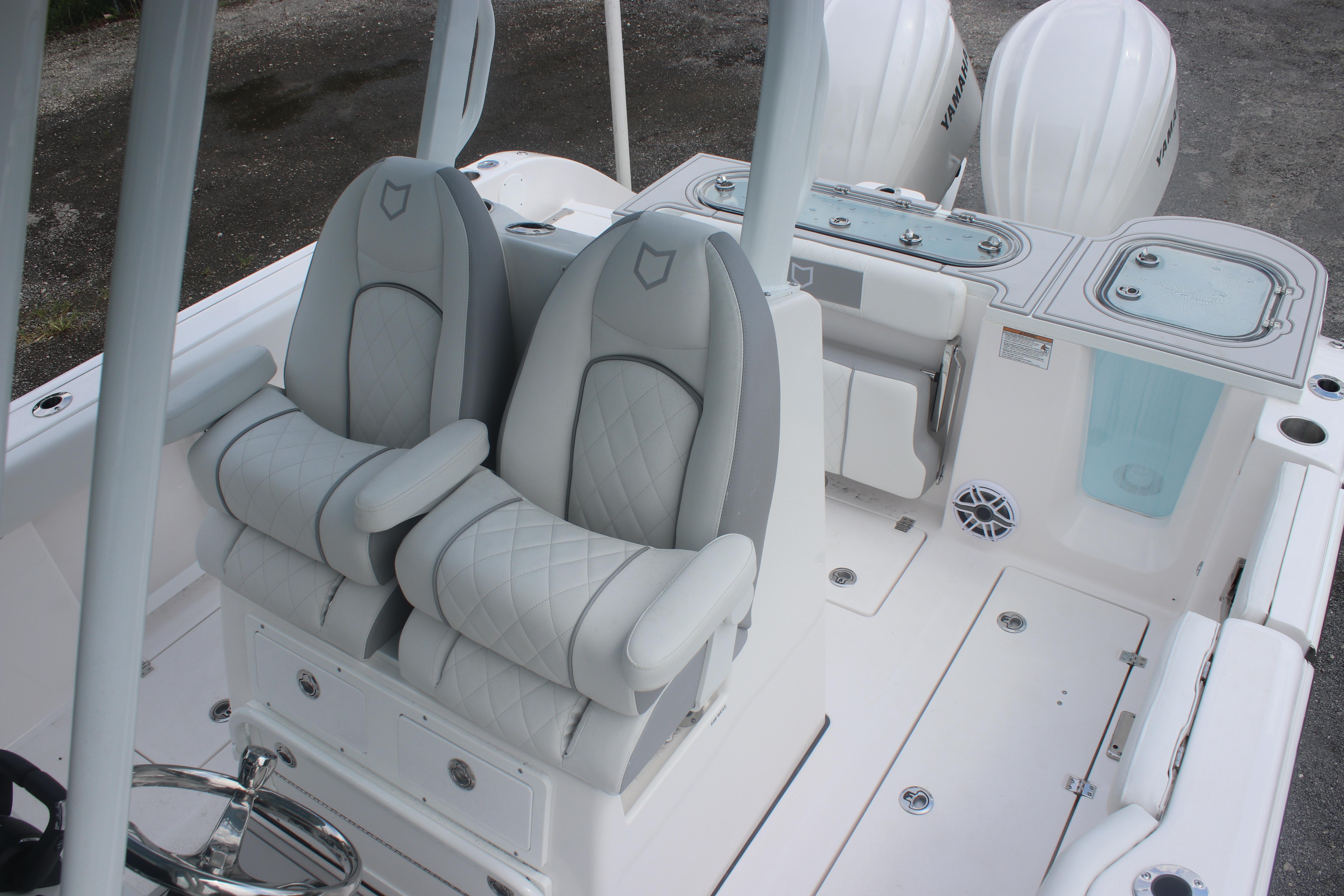 2026 Sea Fox 288 Commander boat interior with dual cushioned seats and Yamaha engines.
