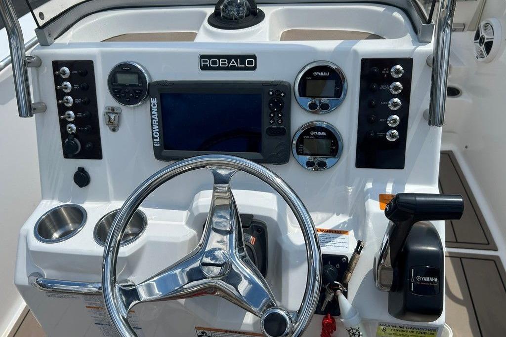 2017 Robalo R200ES boat dashboard with steering wheel, controls, and navigation system.