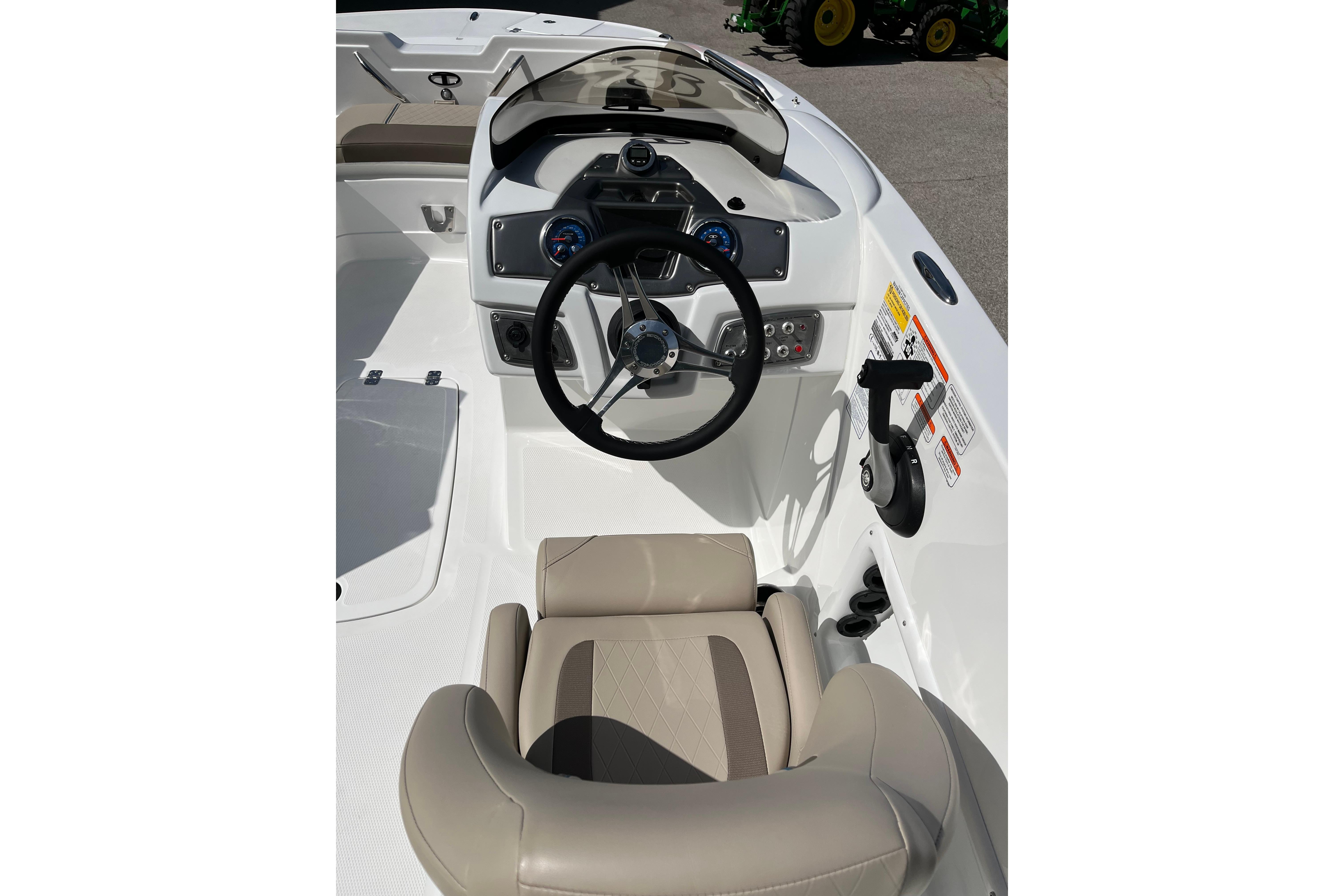 Interior view of 2026 Tahoe 1950 boat cockpit with steering wheel and controls.