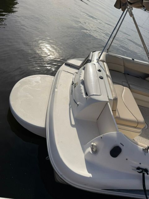 The image shows the rear of a 2001 Sea Ray 210 Sundeck boat on the water.