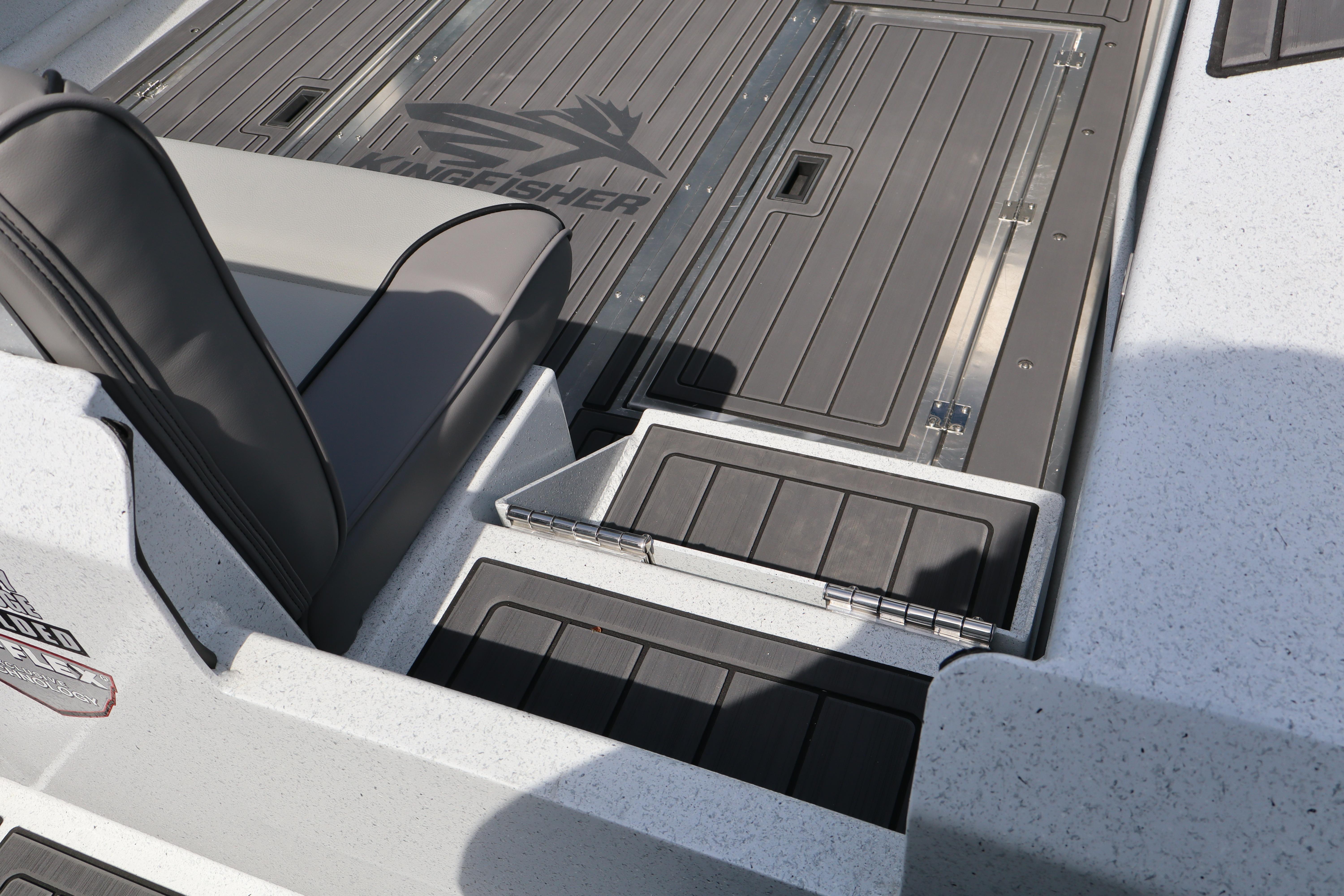 Interior view of 2026 KingFisher 25 XAC boat, featuring sleek seating and storage compartments.
