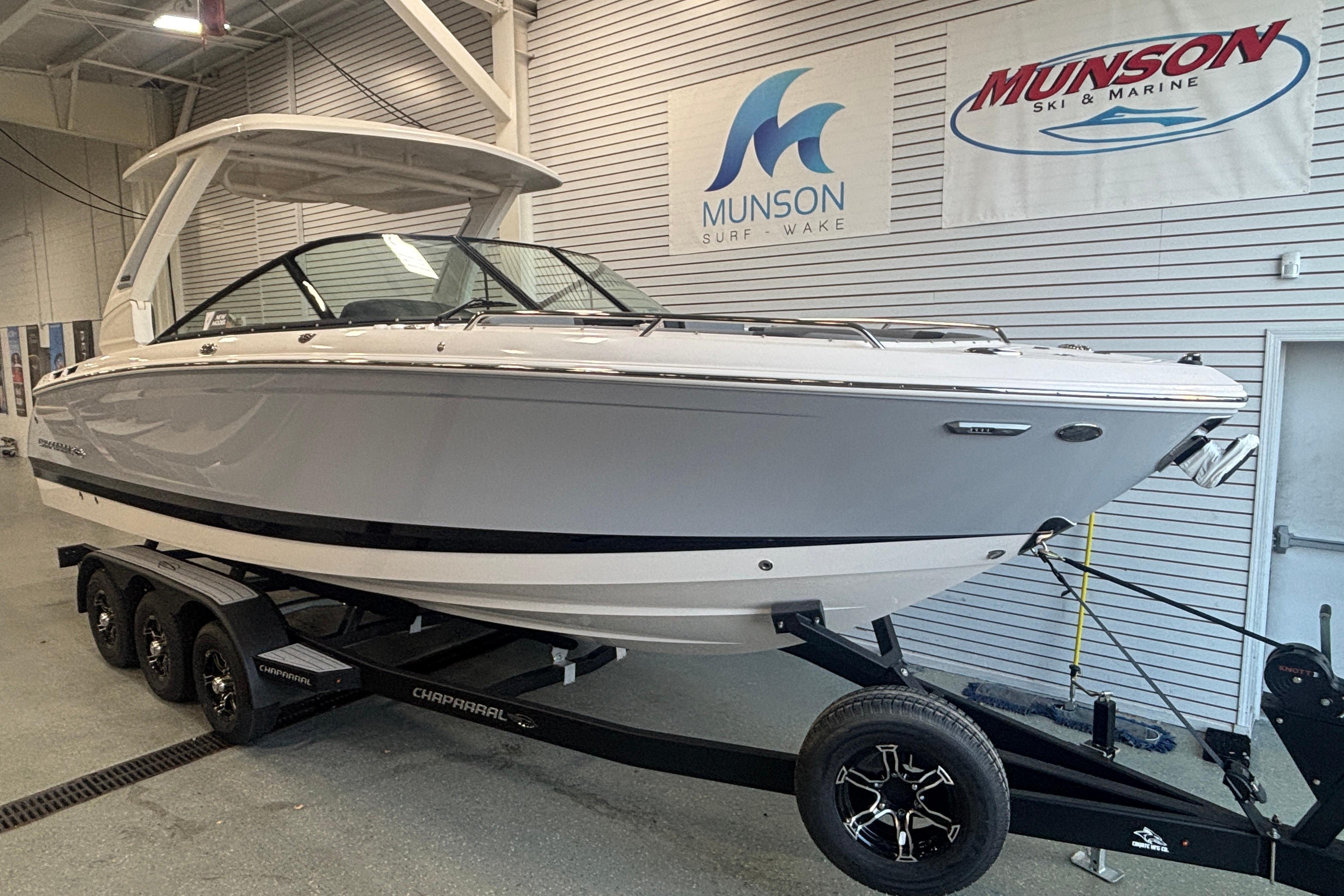 2026 Chaparral SSX 30 boat on trailer in showroom, Munson Ski & Marine banners visible.