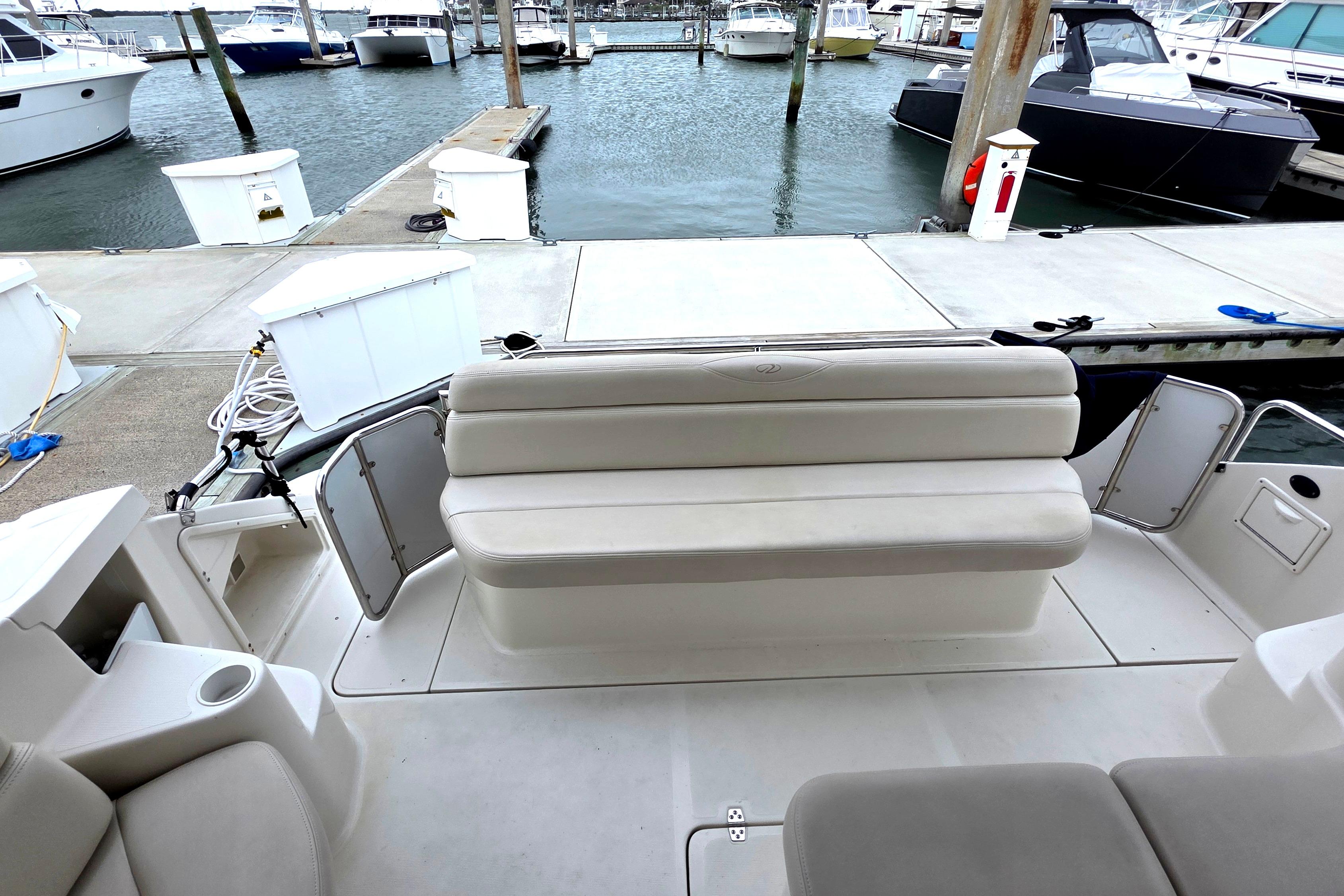 2002 Regal Commodore 4260 yacht interior with seating, docked at marina.