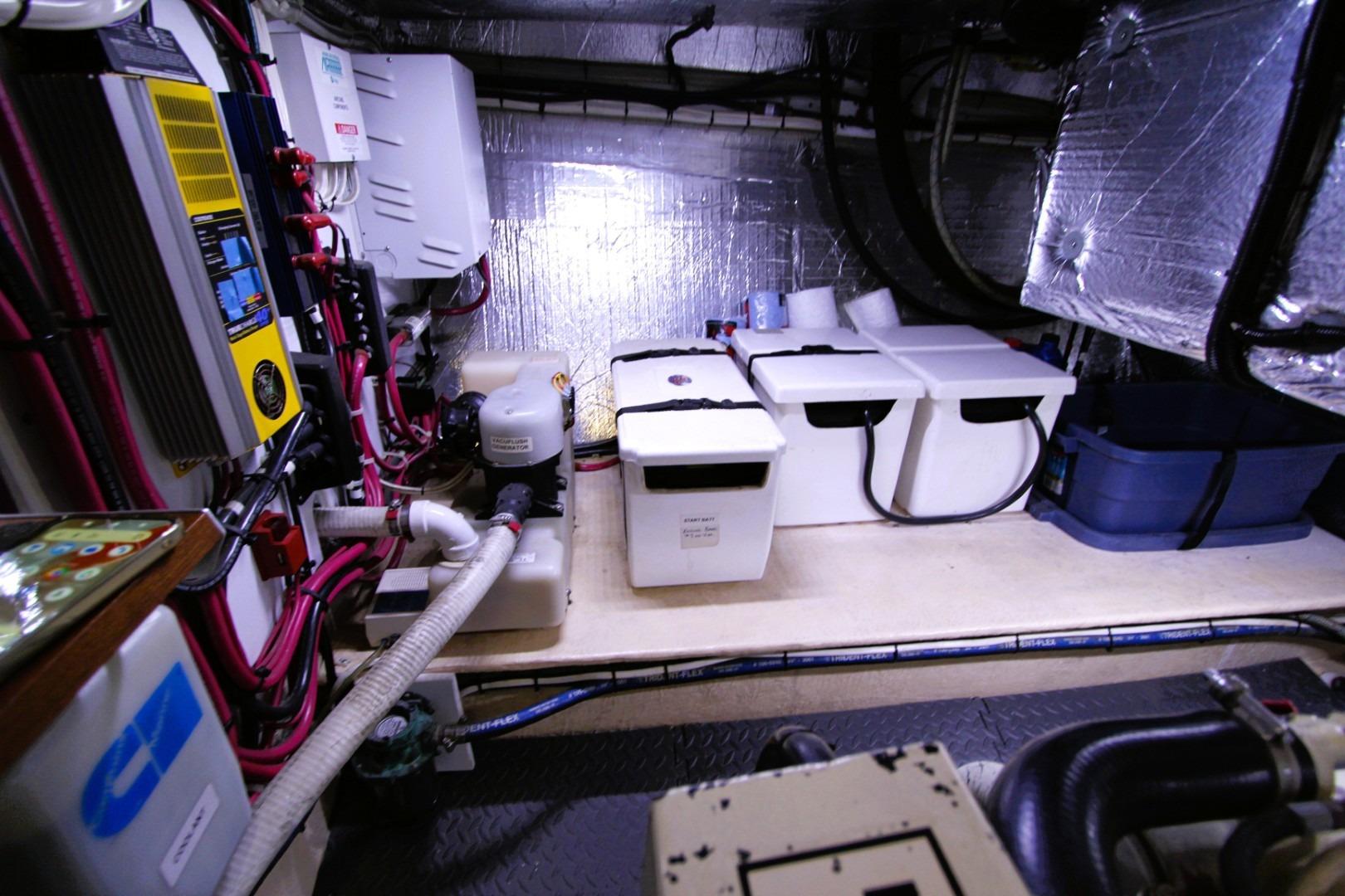 Engine room of a 2002 Nordic Tug 37, featuring equipment and storage containers.