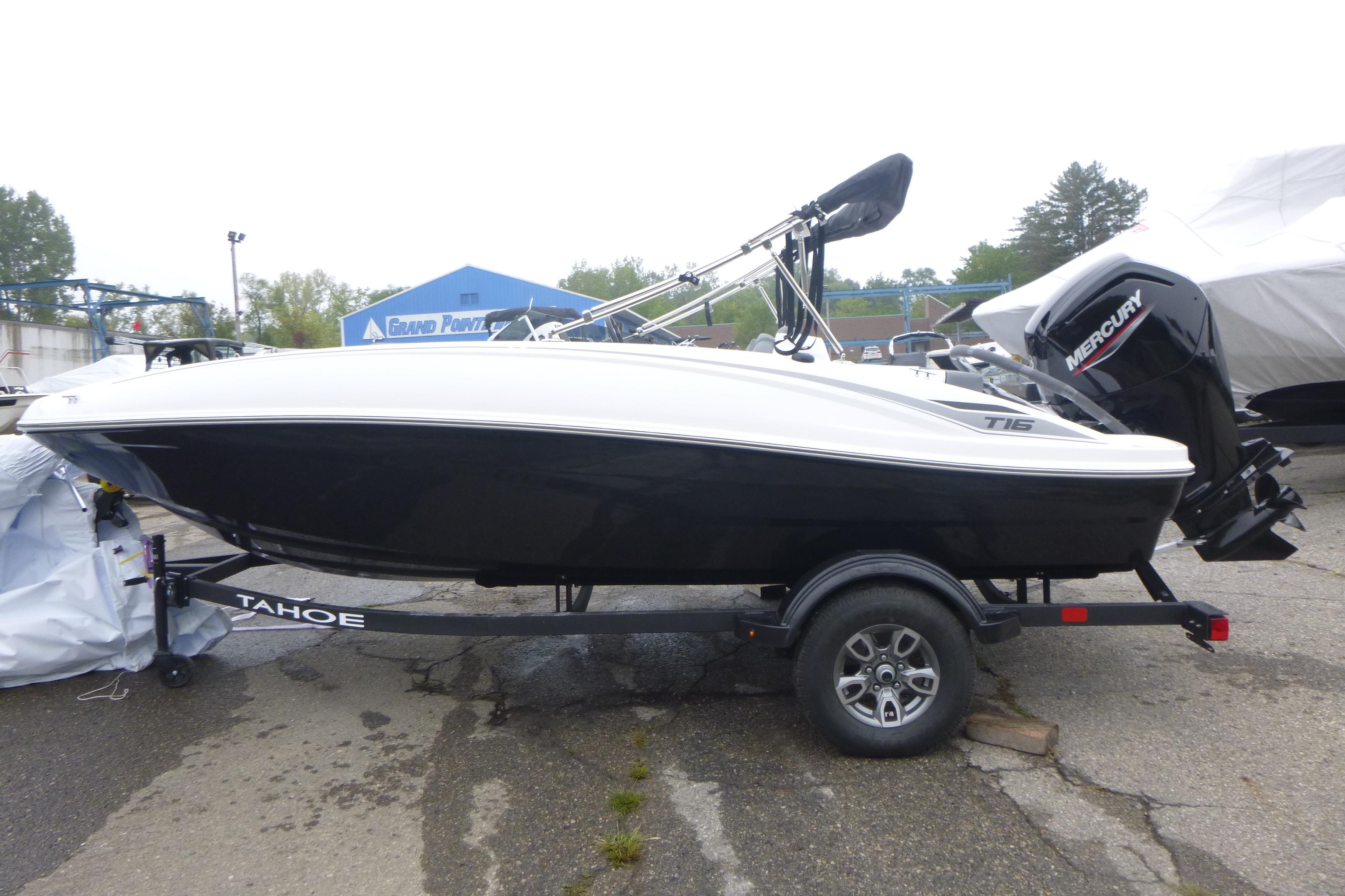 2026 Tahoe T16 boat on trailer with Mercury outboard motor, parked outdoors.