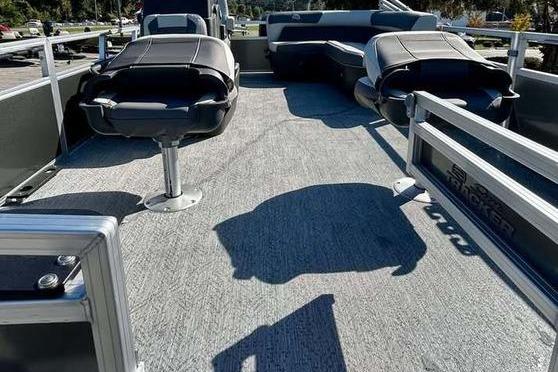 2026 Sun Tracker Bass Buggy 16 XL Select pontoon boat interior with seating and carpeted deck.