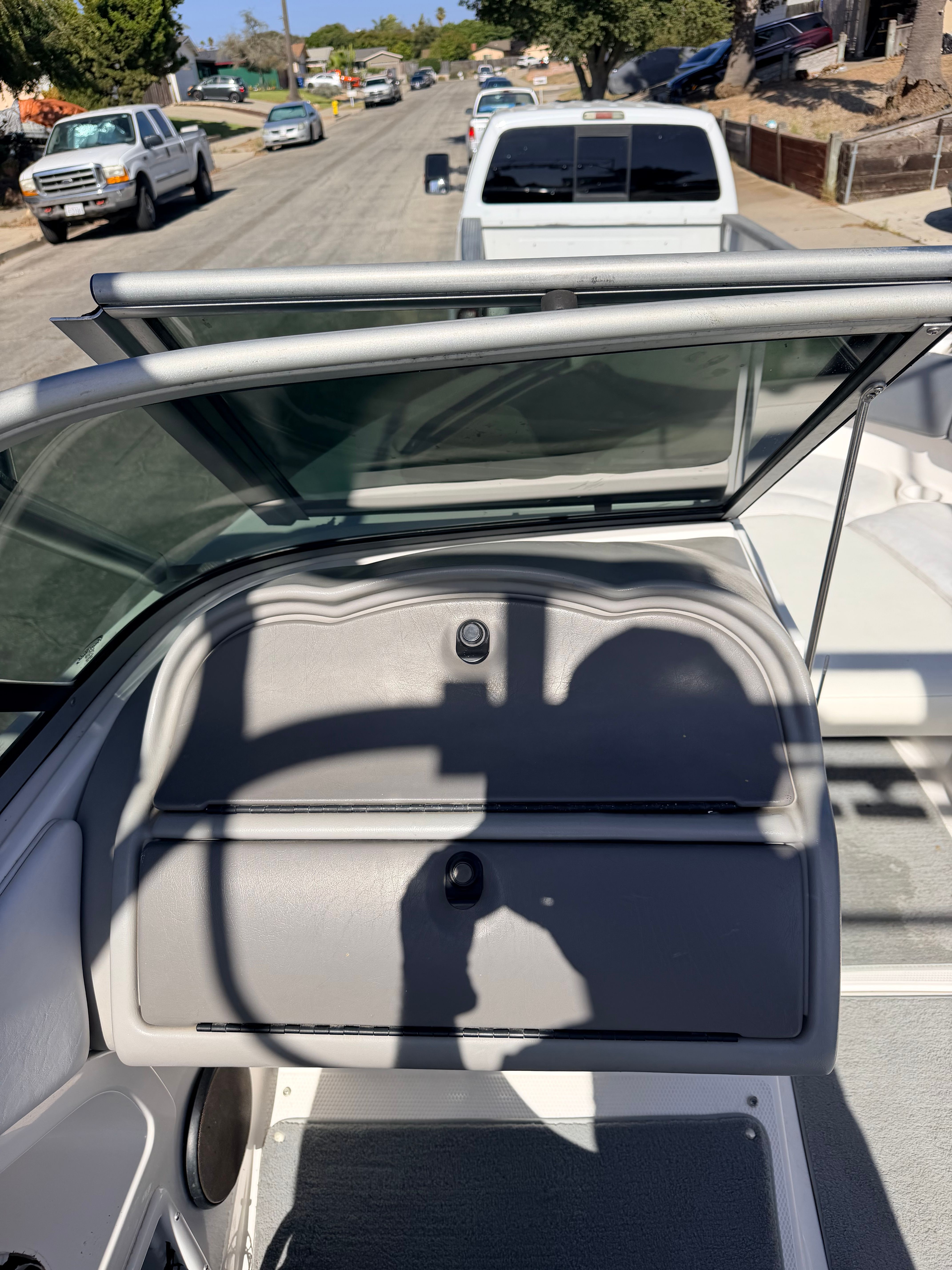 The image shows the cockpit of a 2005 Yamaha AR230 boat parked on a street.