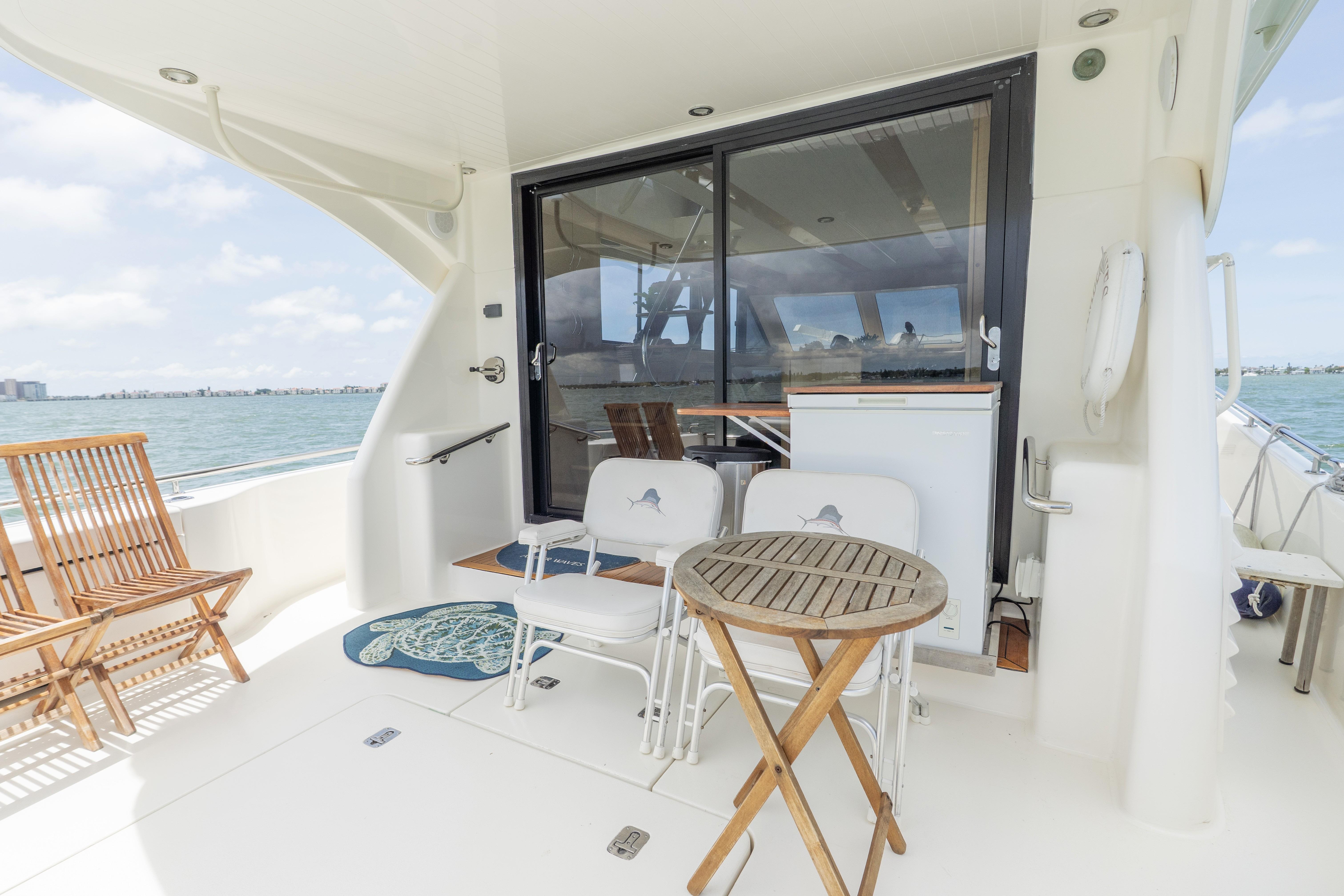 2008 Maritimo 52 yacht deck with chairs, table, and ocean view.