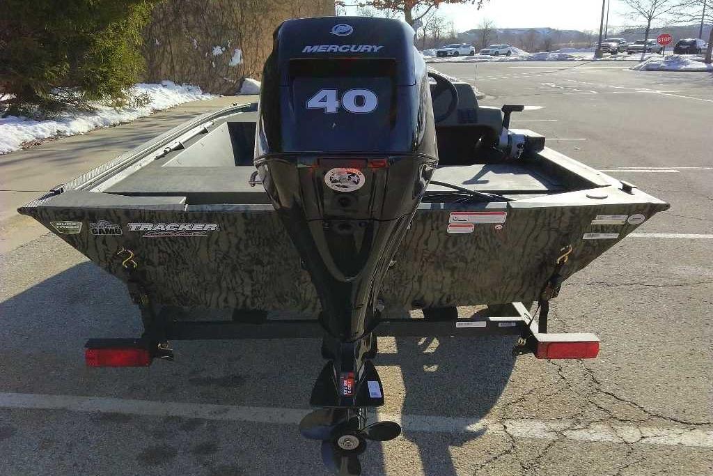 2026 Tracker Grizzly 1648 SC boat with Mercury 40 engine in parking lot.