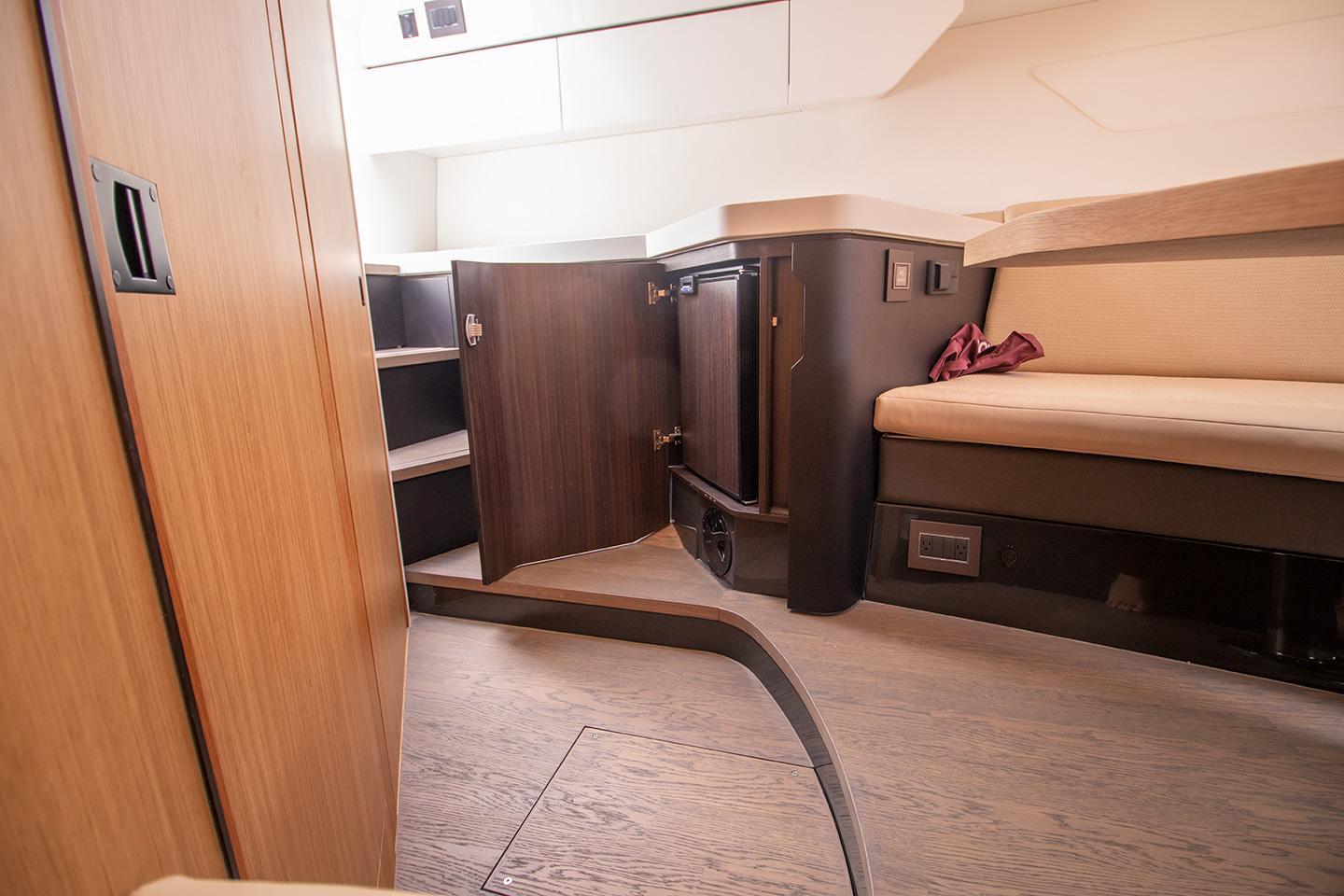 Interior cabin of 2021 Fairline F Line 33 yacht with wooden cabinetry and seating.