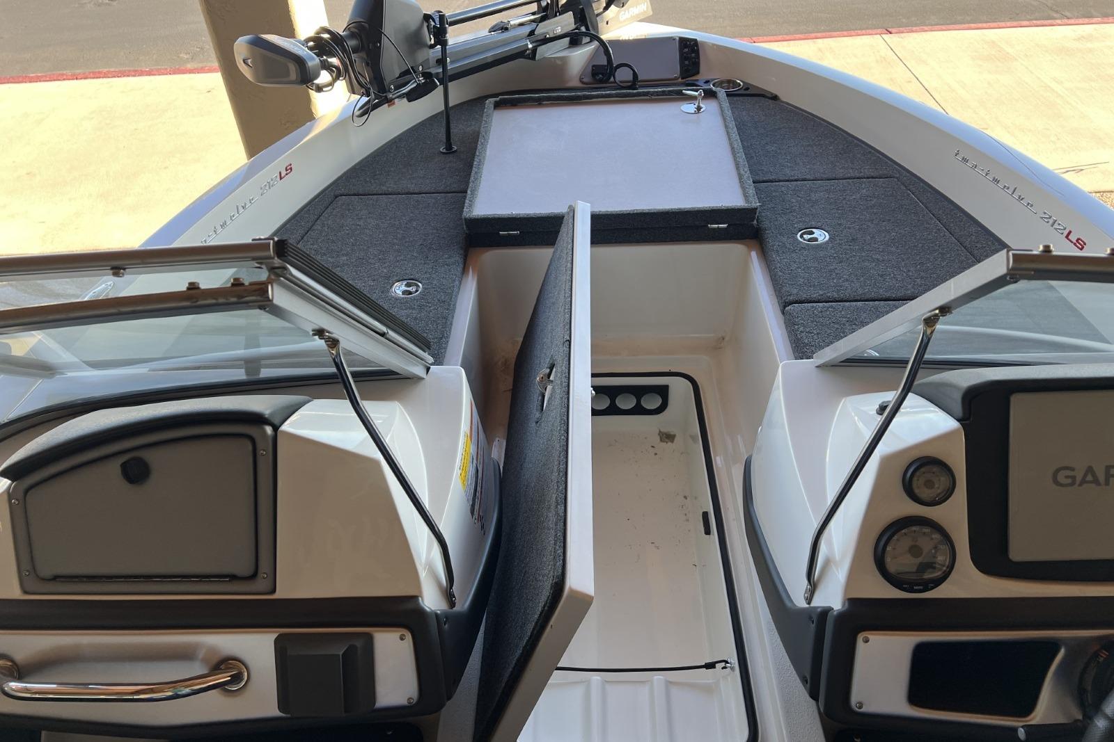 2025 Ranger 212LS boat interior with open storage compartments and control panel.