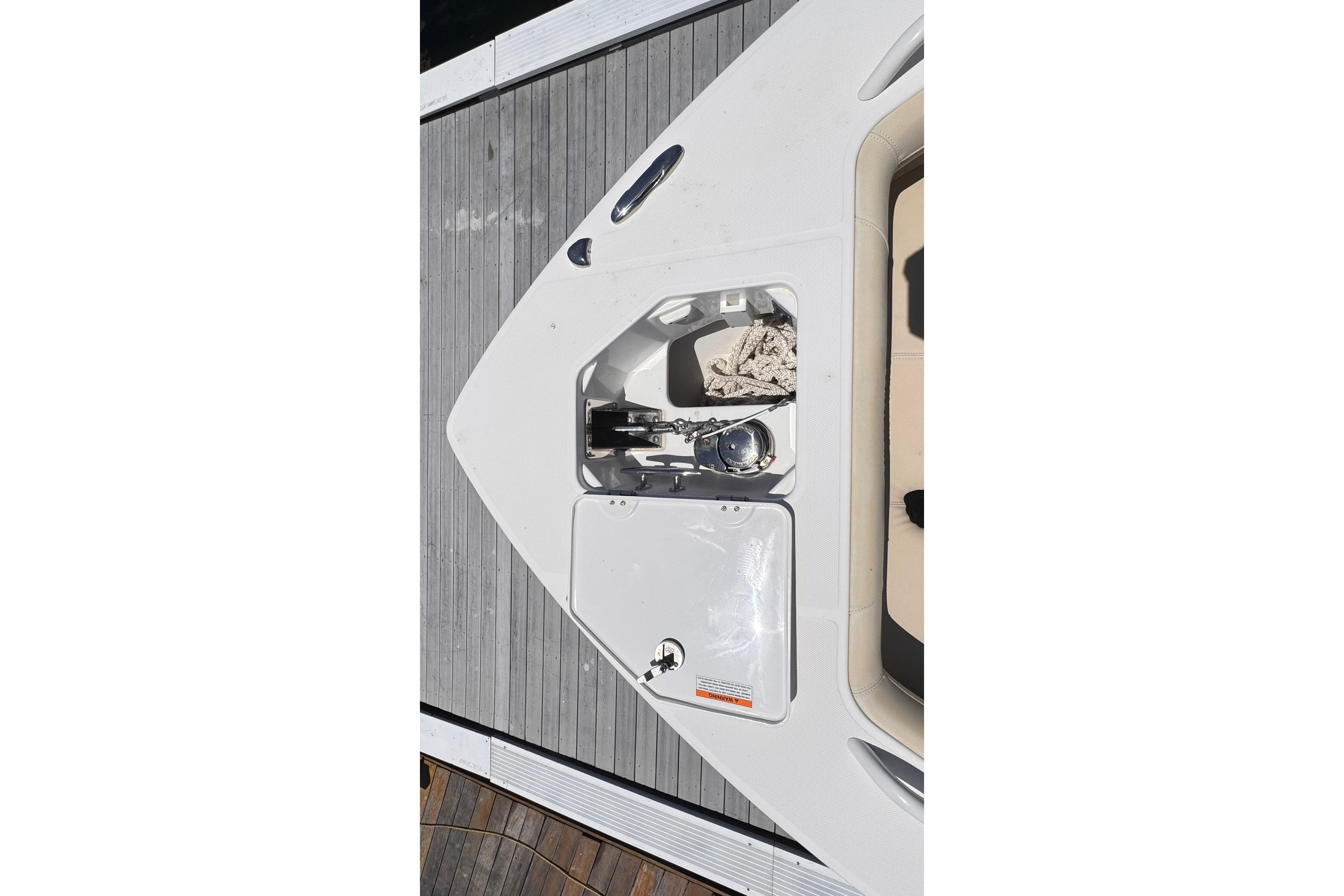 2018 Everglades 253 Center Console boat anchor compartment with rope and winch.