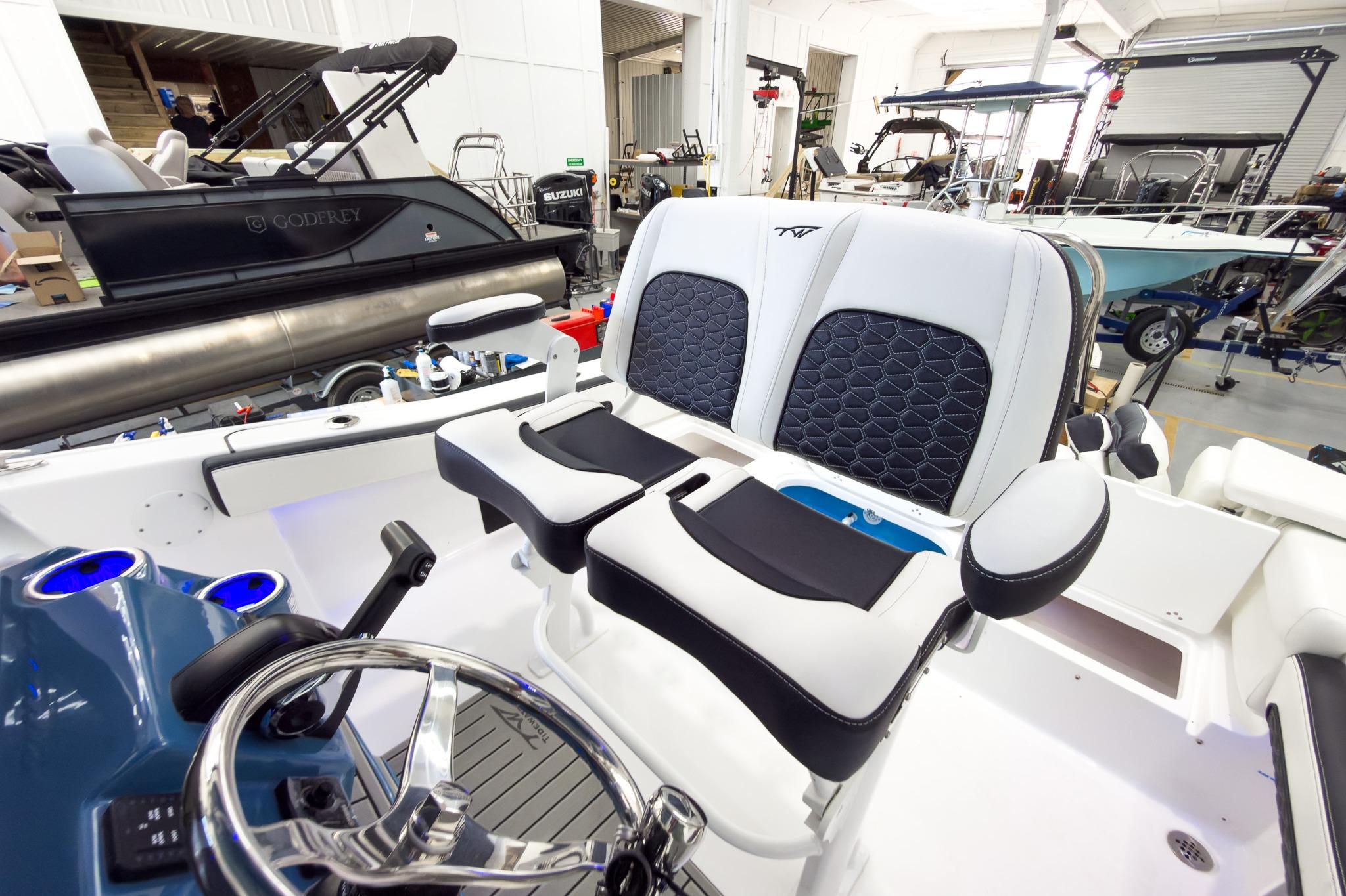 Interior view of a modern boat with stylish seating and a sleek helm station.